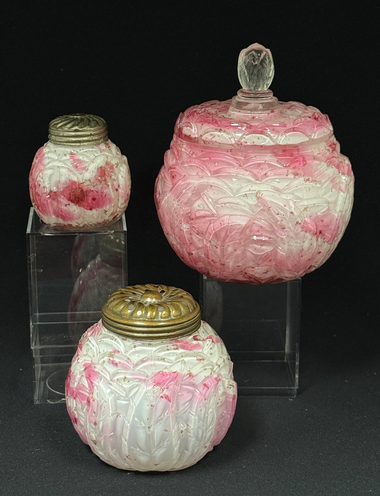 3 Opalescent Splatter Items: 3 Opalescent leaf mold cranberry splatter covered sugar bowl, salt shaker, and sugar shaker; ht. covered sugar 5 1/2". CONDITION: internal rim chip on covered sugar.
