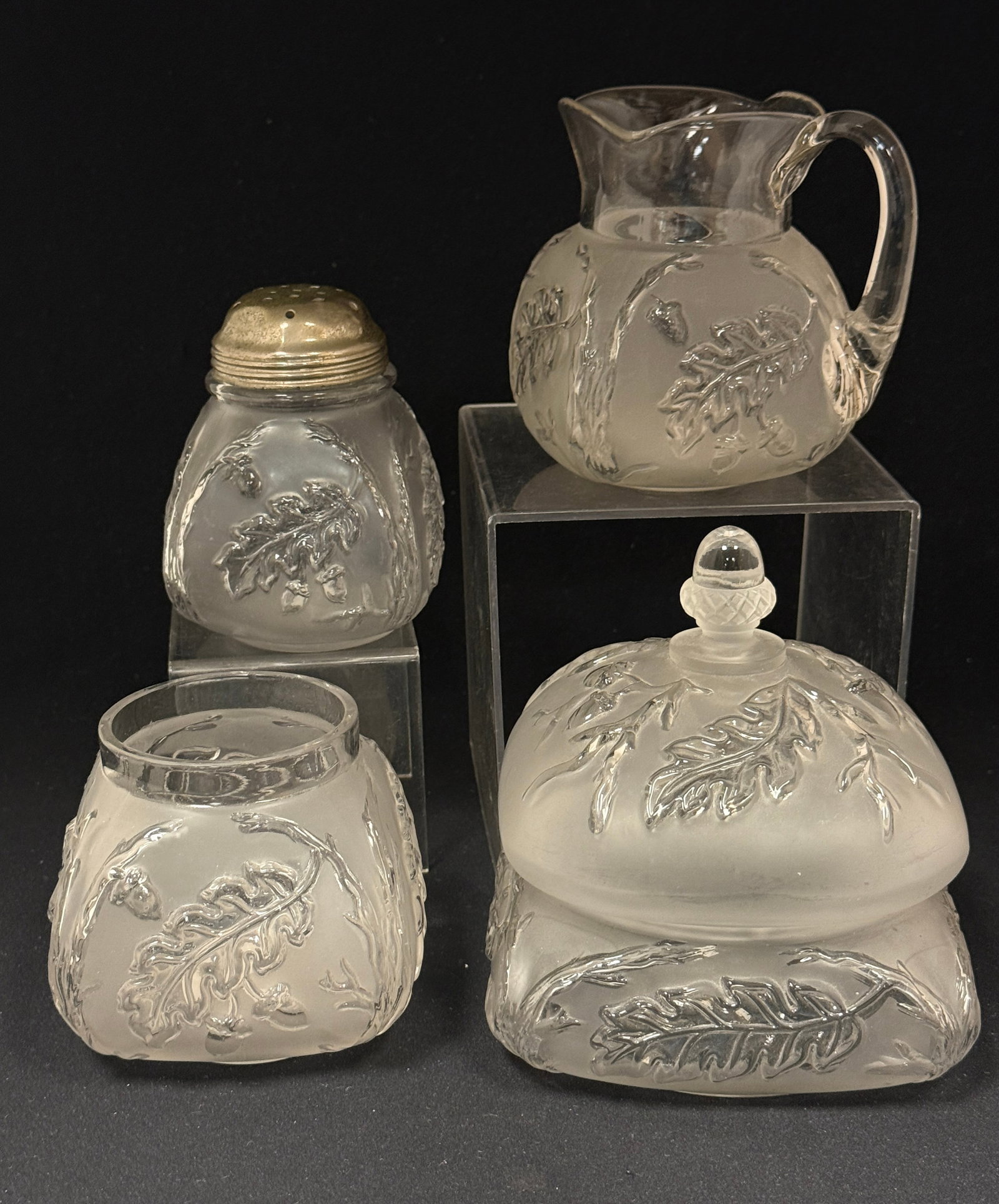 4 Northwood Royal Oak Items: 4 Northwood Royal Oak items: covered butter, open sugar, creamer and sugar shaker, tallest 6" ht. CONDITION: no chips, cracks, repairs, or material defects found, Jaremos attempts to call any