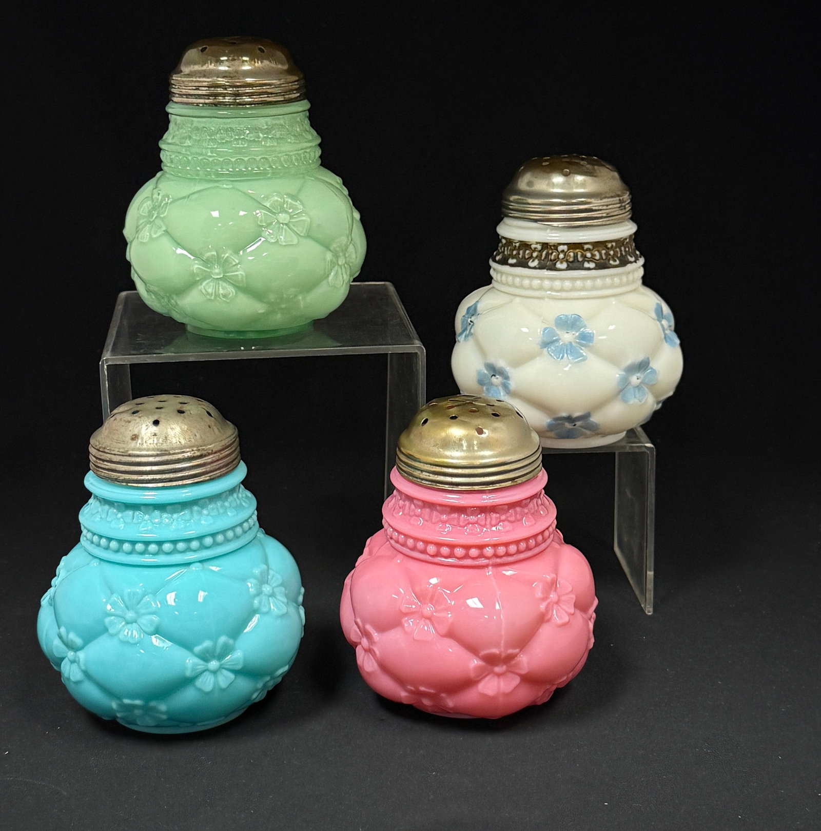 4 Quilted Phlox Sugar Shakers: 4 quilted phlox sugar shakers in pink, blue, green, blue/white; ht. 5". CONDITION: rough rims, see picture.
