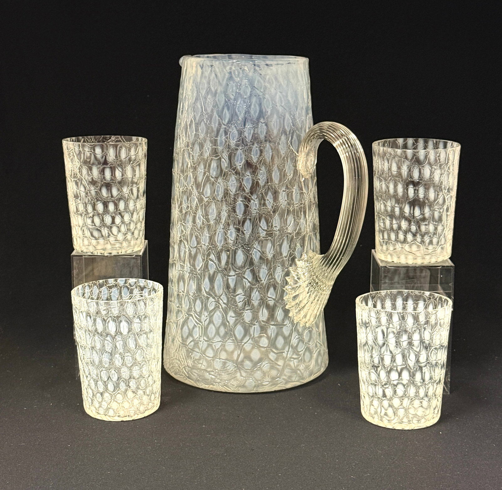 Diamond Optic Tankard/Tumblers: Diamond optic clear crackle tankard with reeded handle and 4 tumblers; ht 10 1/2". CONDITION: no chips, cracks, repairs, or material defects found, Jaremos attempts to call any material flaw that