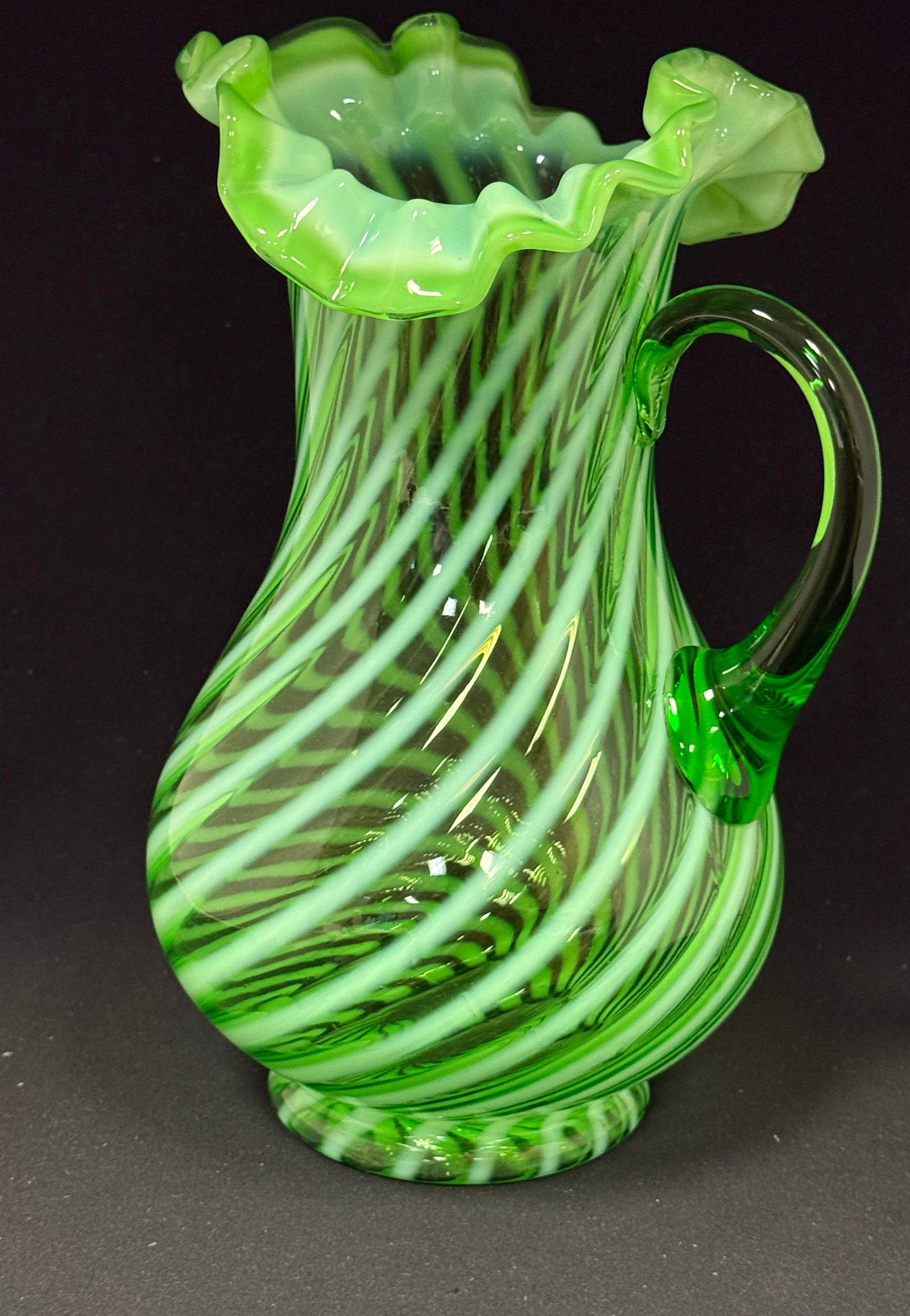 Jefferson Green Swirl Pitcher: Green Jefferson swirl pitcher; ht. 11". CONDITION: no chips, cracks, repairs, or material defects found, Jaremos attempts to call any material flaw that affects the price, but minor scratches and