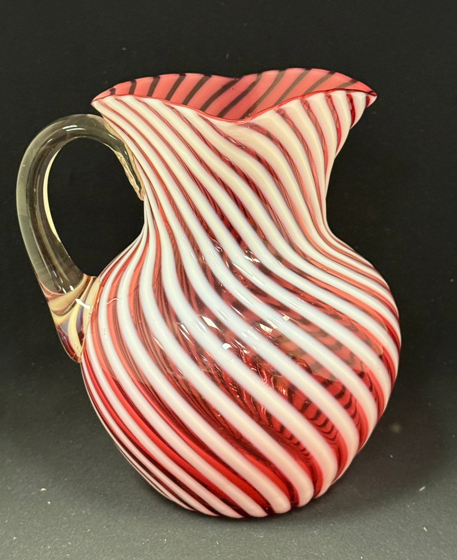 Hobbs Cranberry Water Pitcher: Hobbs cranberry optic swirl water pitcher; ht. 8 1/2". CONDITION: no chips, cracks, repairs, or material defects found, Jaremos attempts to call any material flaw that affects the price, but minor