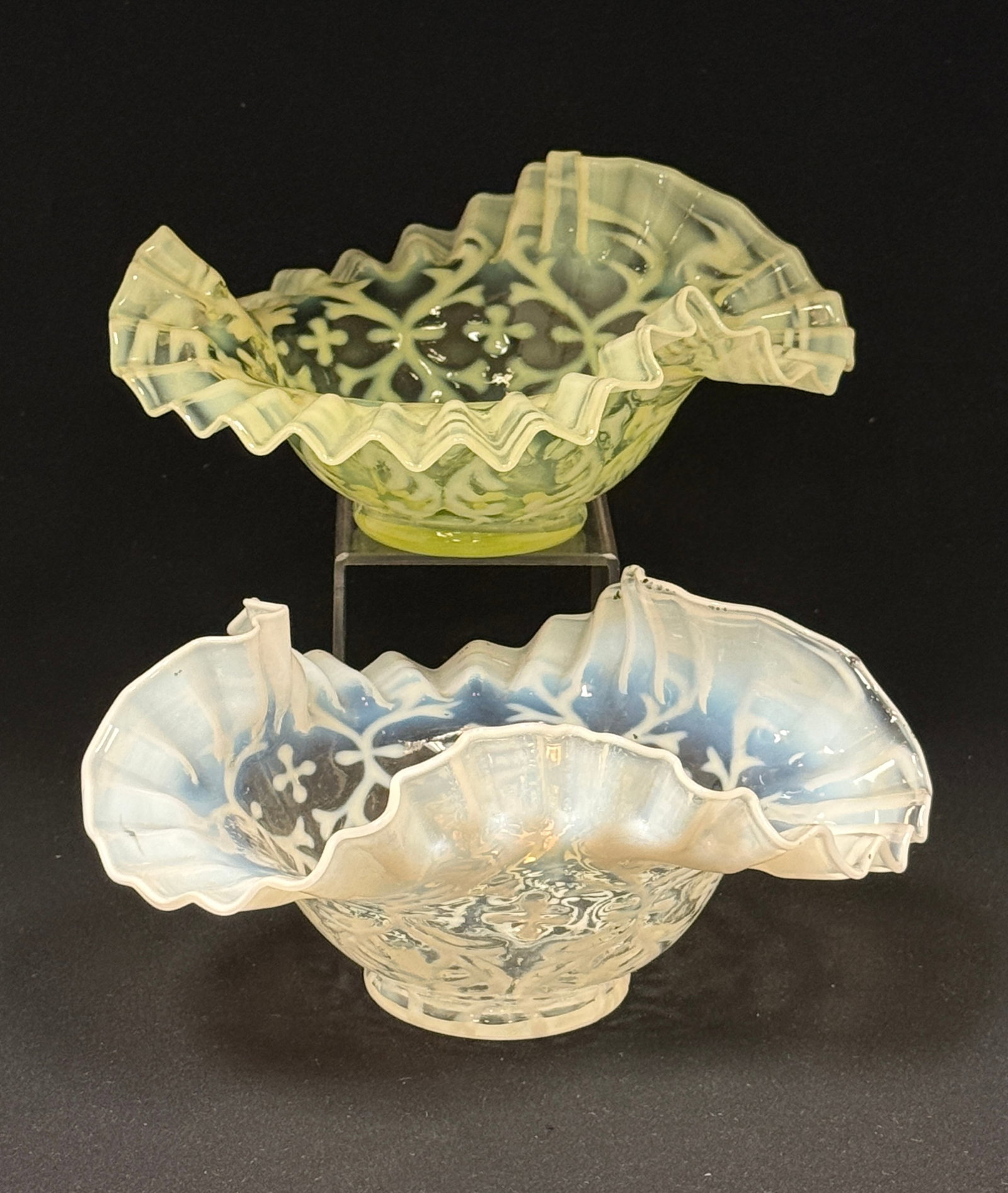 2 Opalescent Ruffle Top Bowls: 2 opalescent ruffle top bowls in the Spanish lace pattern one white and one uranium yellow; diameter 7 3/4", foot diameter 2 1/2". CONDITION: no chips, cracks, repairs, or material defects found, Jare