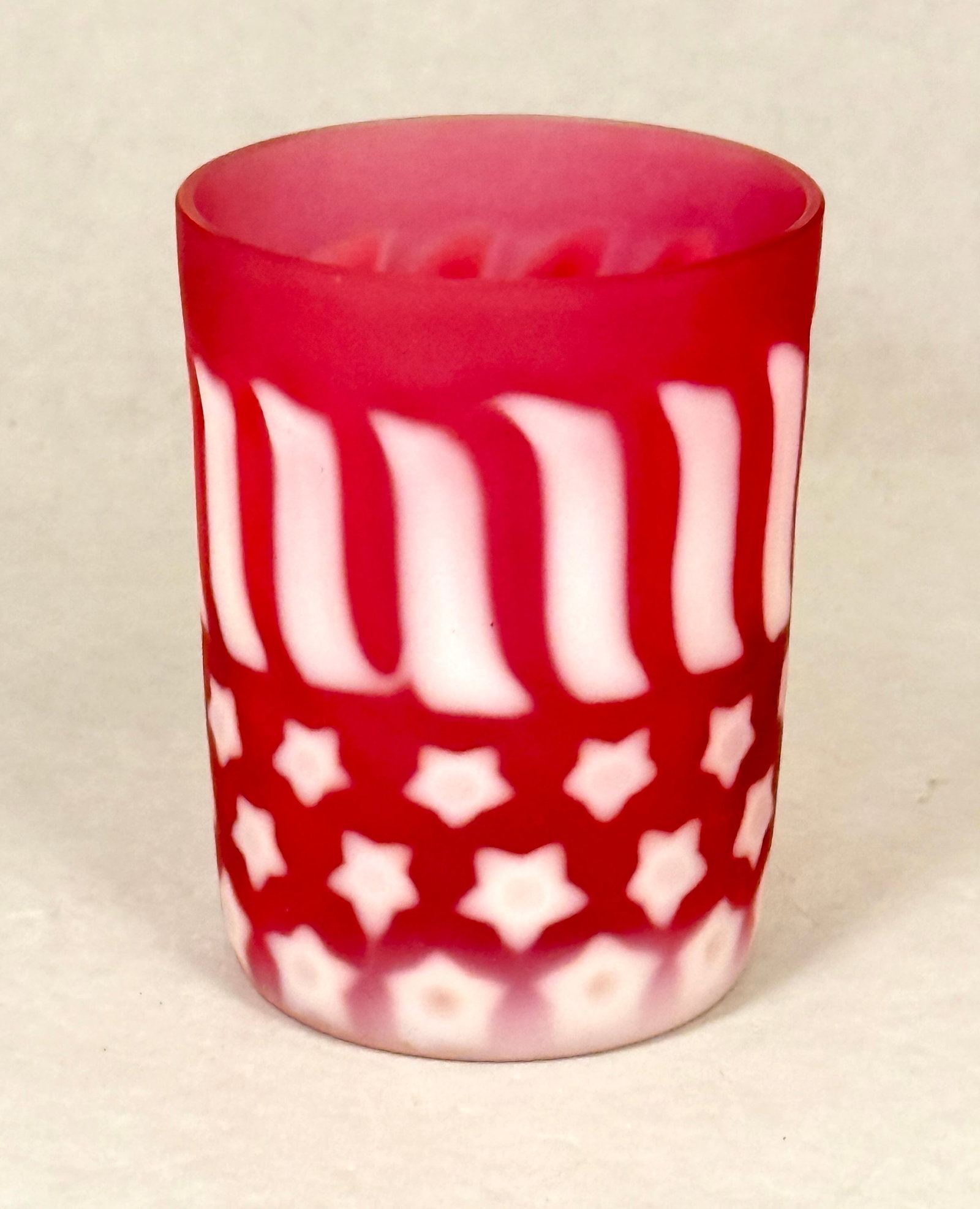 Opalescent Stars & Stripes Tumber: Opalescent stars and strips cranberry tumbler; ht. 3 3/4". CONDITION: no chips, cracks, repairs, or material defects found, Jaremos attempts to call any material flaw that affects the price, but