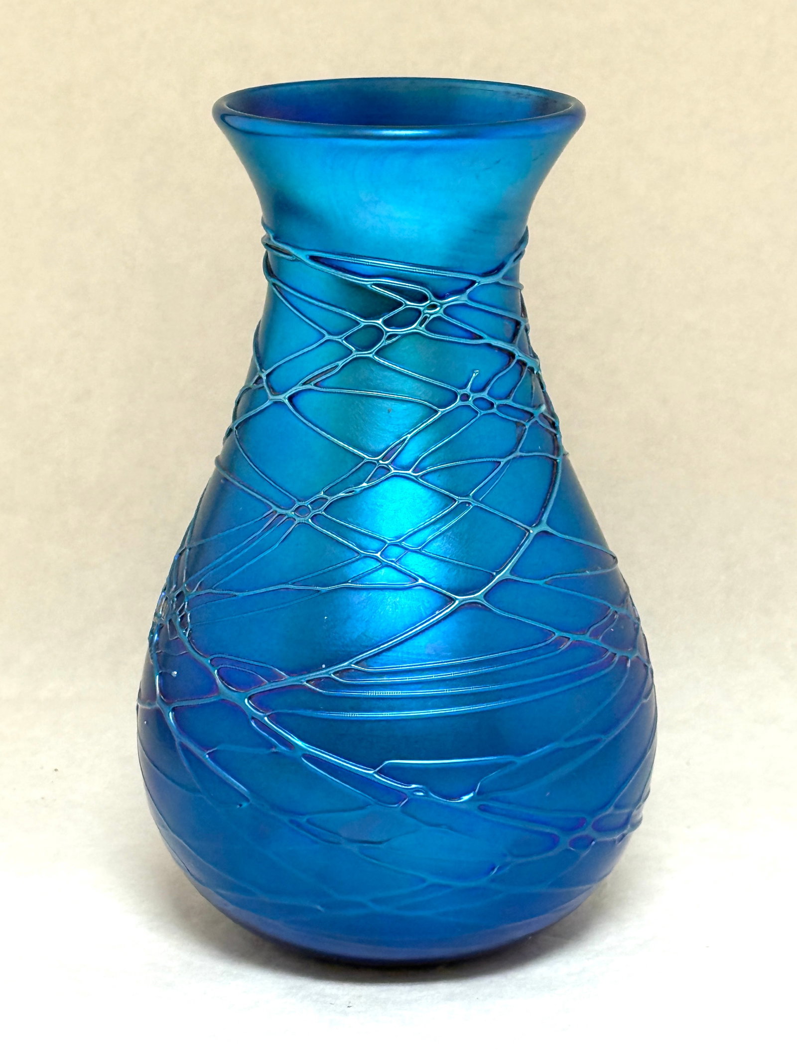 Durand Threaded Glass Vase: Durand iridescent blue glass vase with overall threading signed V Durand 101-7, 7" ht. CONDITION: no chips, cracks, repairs, or material defects found, Jaremos attempts to call any material flaw that