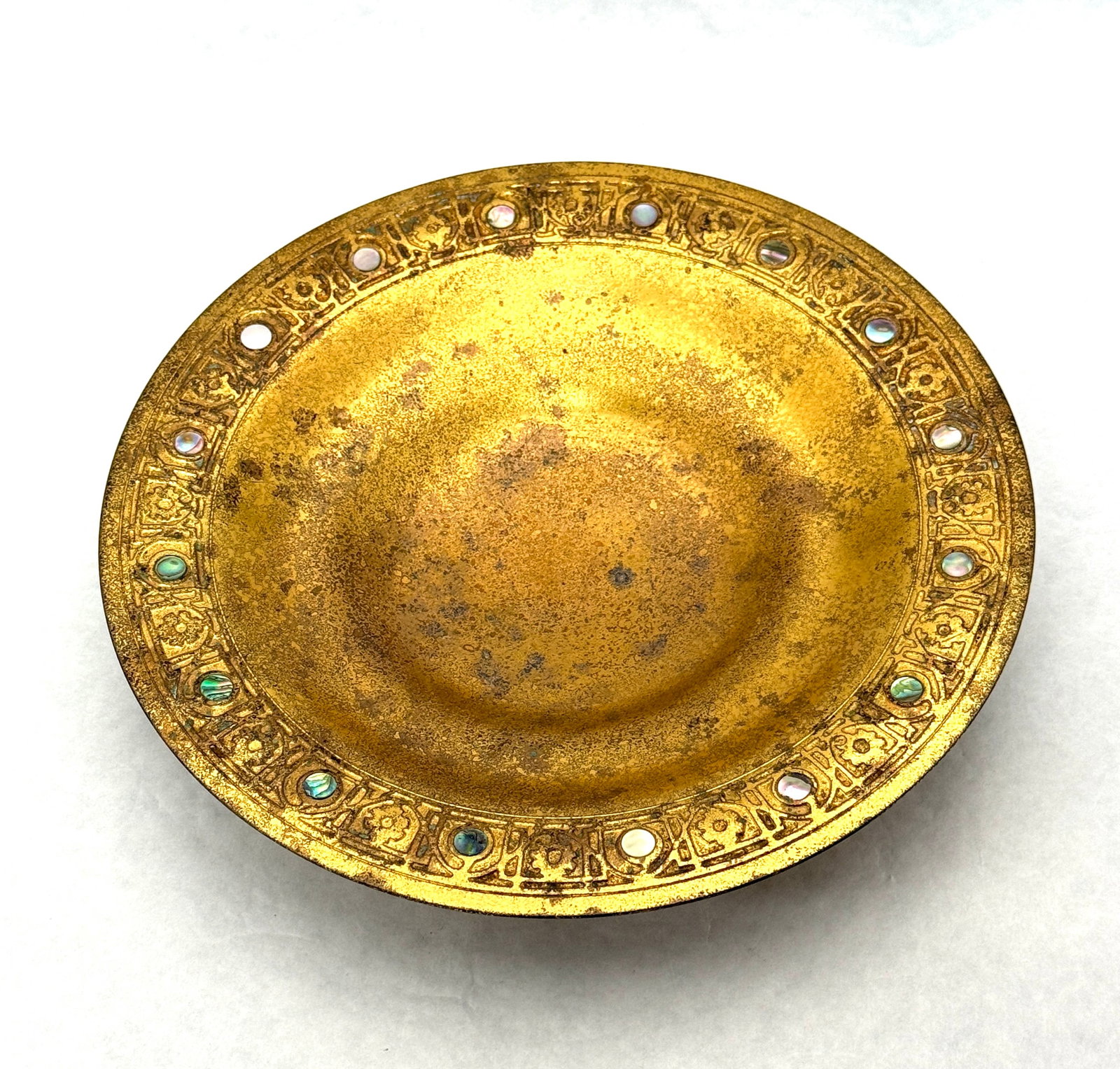 Tiffany Bronze Plate: Tiffany bronze plate with mother of pearl inlay, stamped Tiffany Studios New York 1723; diameter 8 7/8". CONDITION: no chips, cracks, repairs, or material defects found, Jaremos attempts to call any