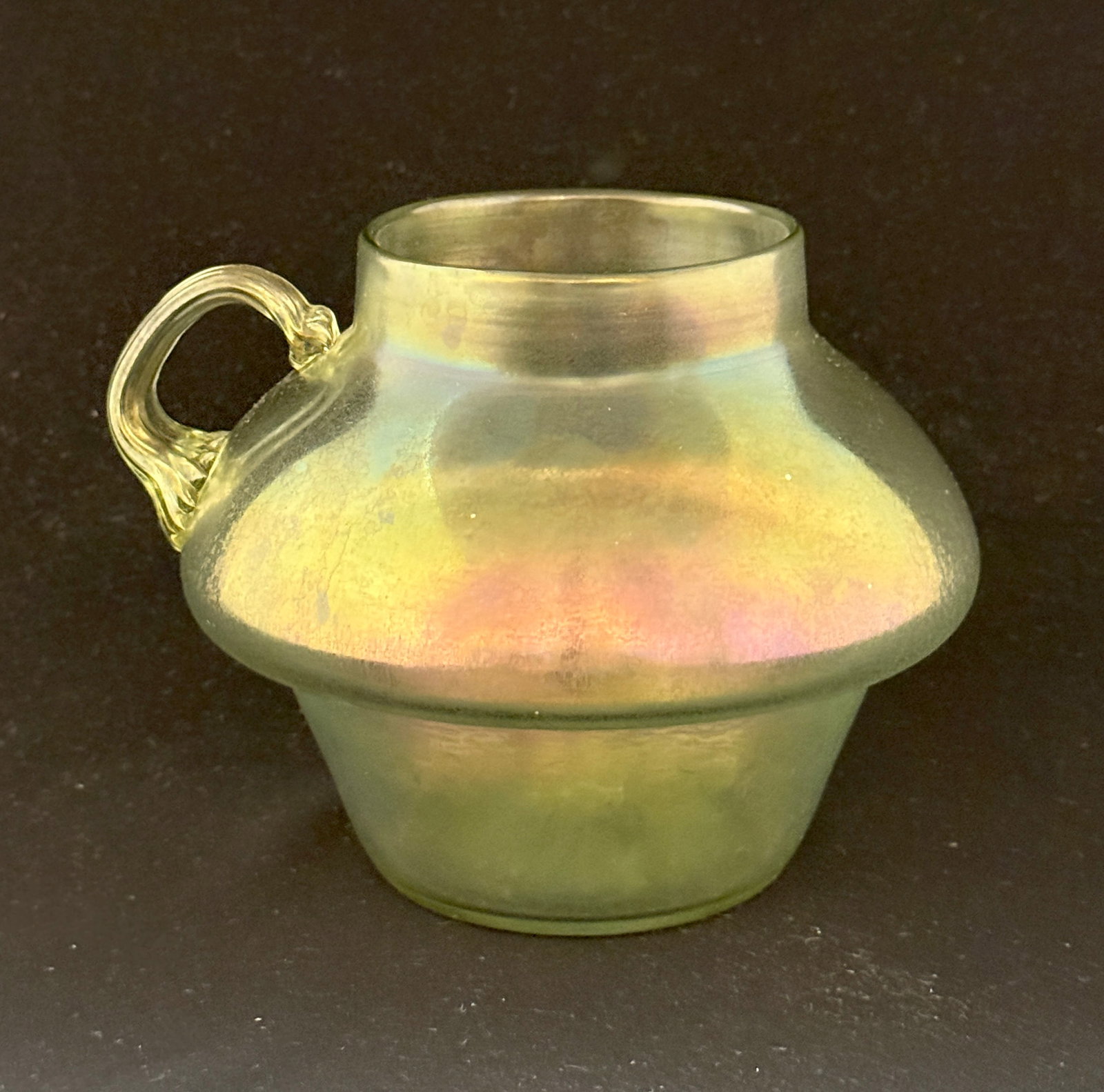 Loetz Olympia Bowl with Handle: Loetz Olympia single handle bowl, ht. 4 1/2". CONDITION: no chips, cracks, repairs, or material defects found, Jaremos attempts to call any material flaw that affects the price, but minor scratches