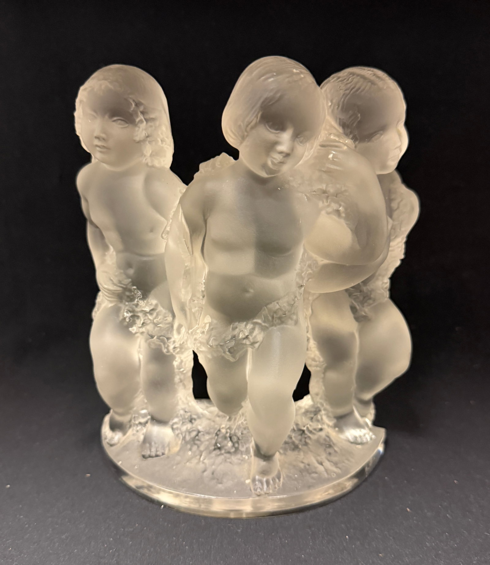 Lalique "Luxemborg" Figurine: Lalique "Luxemborg" figurine of 3 children, no signature but has an impressed L 1; ht. 8". CONDITION: manufacturing flaw crack, and chip to foot see picture.