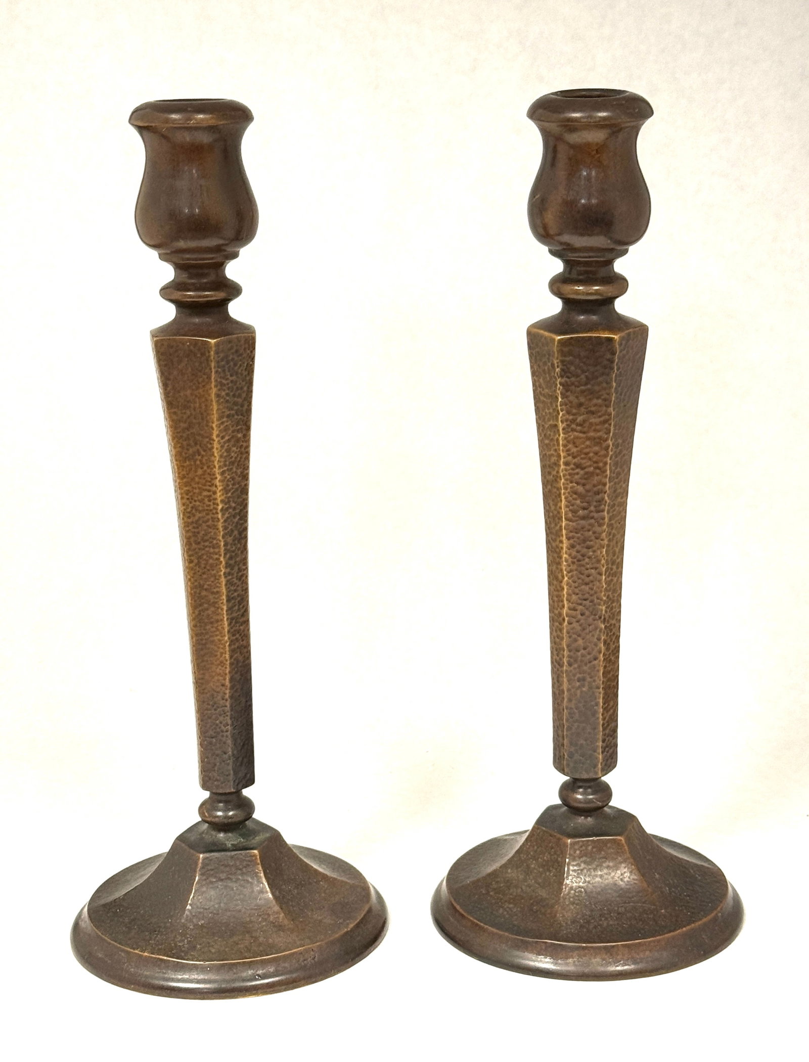 Pair of Art Nuevo Candlesticks: Pair of Art Nuevo hammered bronze candlesticks; ht. 11 1/2". CONDITION: no chips, cracks, repairs or material defects found, Jaremos attempts to call any material flaw that affects the price, but mino