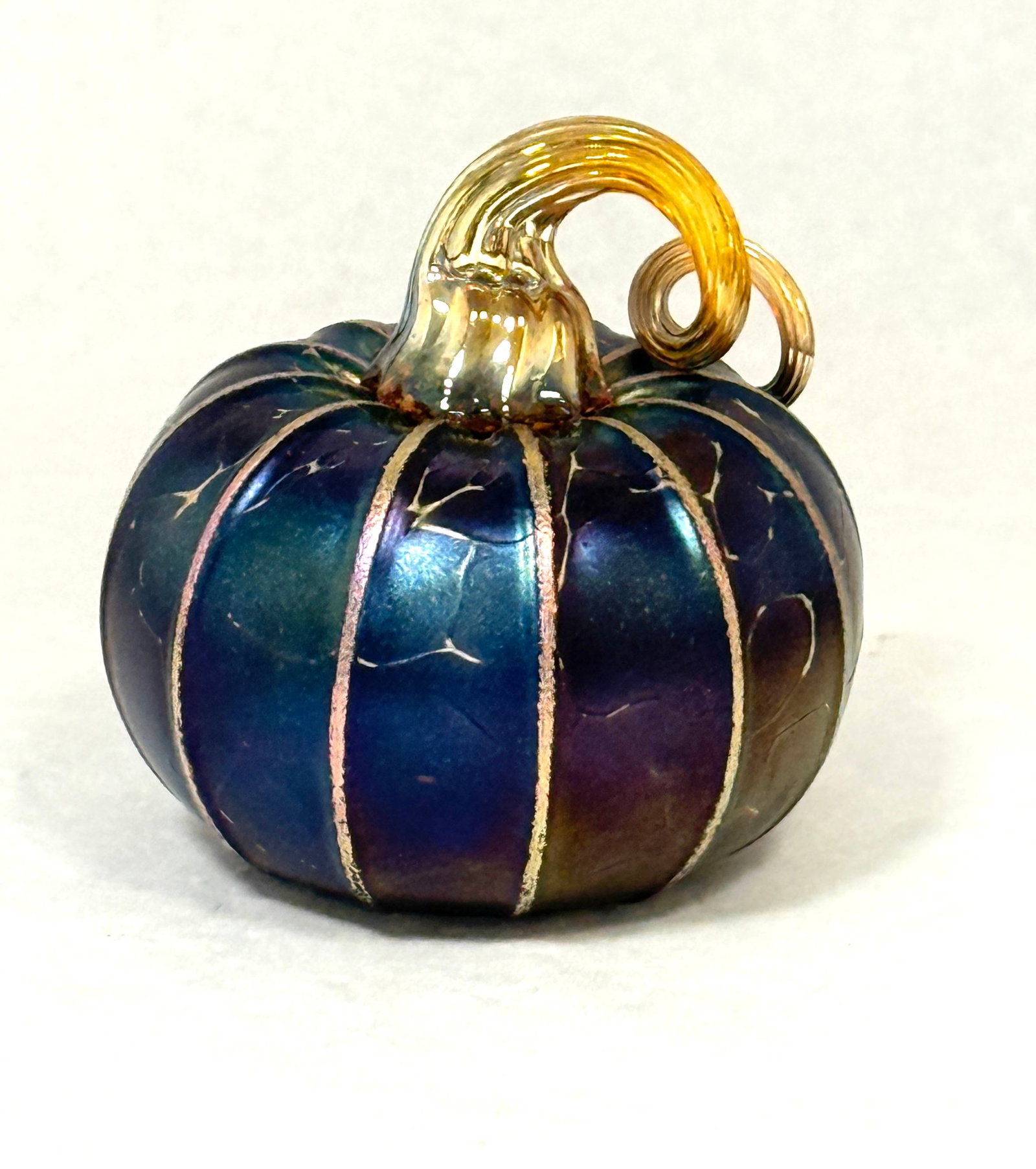 Jack Pine Blue Iridescent Gourd: Jack Pine blue iridescent gourd; 3" diameter. CONDITION: no chips, cracks, repairs or material defects found, Jaremos attempts to call any material flaw that affects the price, but minor scratches