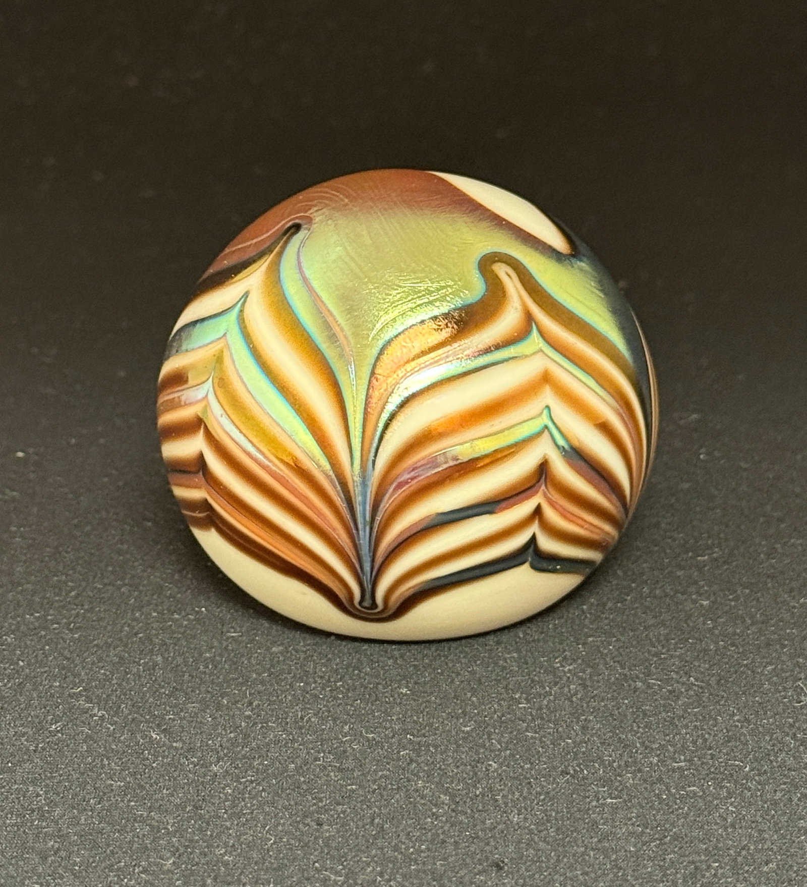 Satava Studios Paperweight: Satava Studios opal paperweight with iridescent gold and red pulled feather, signed Satava 82, 2 1/2" wide. CONDITION: no chips, cracks, repairs, or material defects found, Jaremos attempts to call