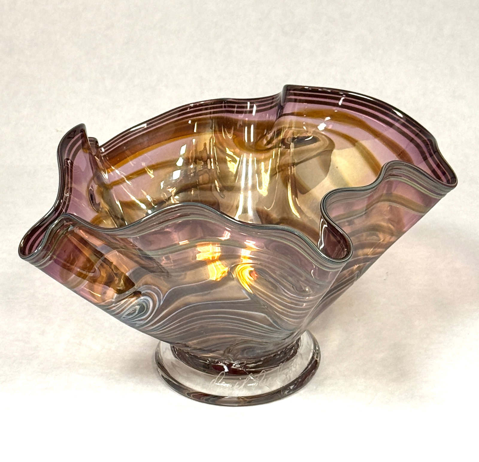 Daniel Read Footed Vase: Daniel Read footed handkerchief bowl with a purple and yellow coil design, signed Daniel Read 7 3/4" wide. CONDITION: no chips, cracks, repairs, or material defects found, Jaremos attempts to call any