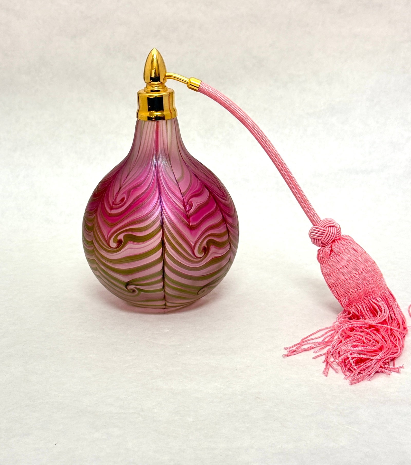 Daniel Lotton Atomizer: Daniel Lotton green and pink hooked feather atomizer, signed Daniel Lotton 2011, 7" ht. CONDITION: no chips, cracks, repairs, or material defects found, Jaremos attempts to call any material flaw that