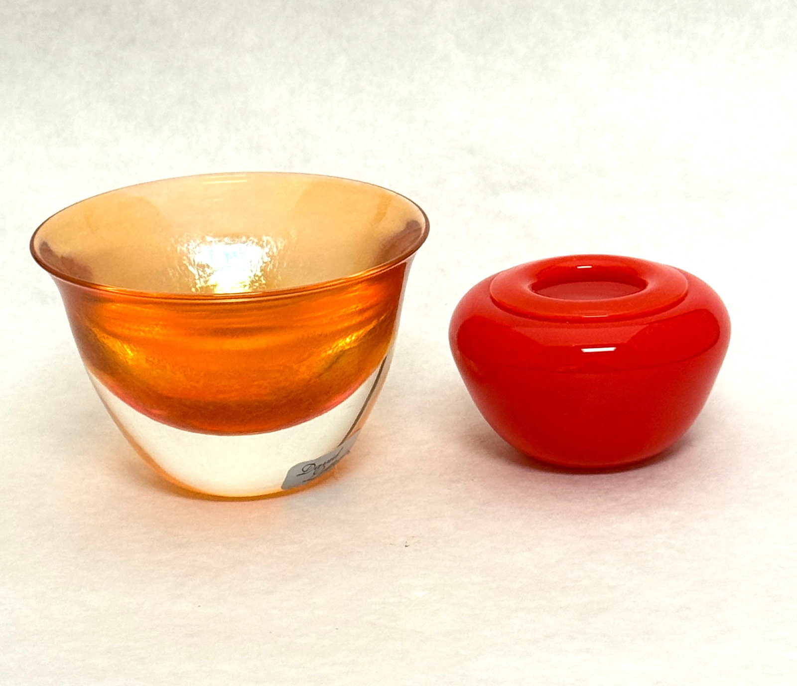 2 Lotton Cabinet Vases: 2 David Lotton glass items including a mandarin red diminutive vase and a orange candle votive, both signed, tallest 2 3/4" ht. CONDITION: no chips, cracks, repairs, or material defects found,