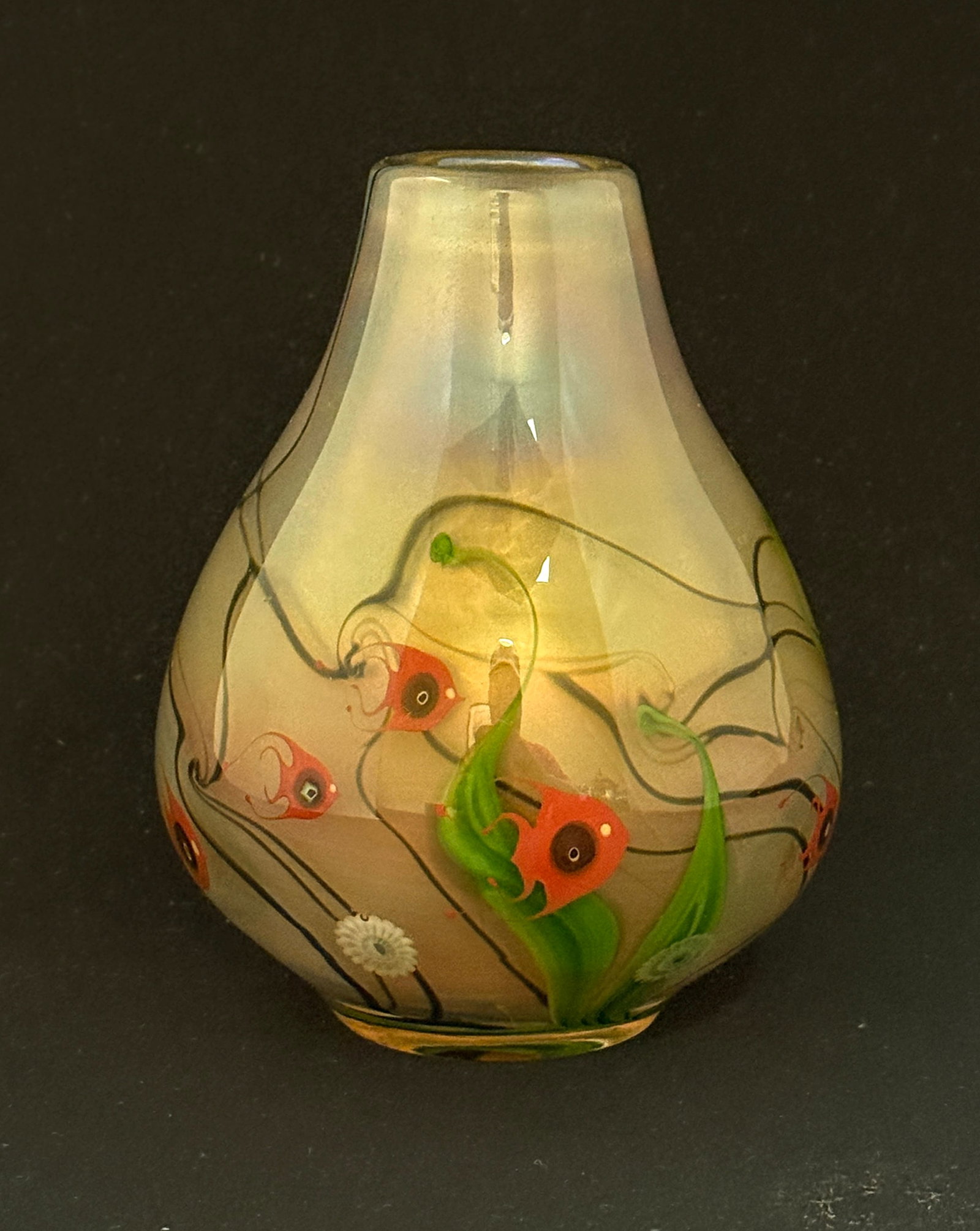 Lundberg Paperweight Vase: Lundberg amber opalescent paperweight glass vase with an underwater scene of swimming fish, signed Lundberg Studios 1977, 5" ht. CONDITION: no chips, cracks, repairs, or material defects found,