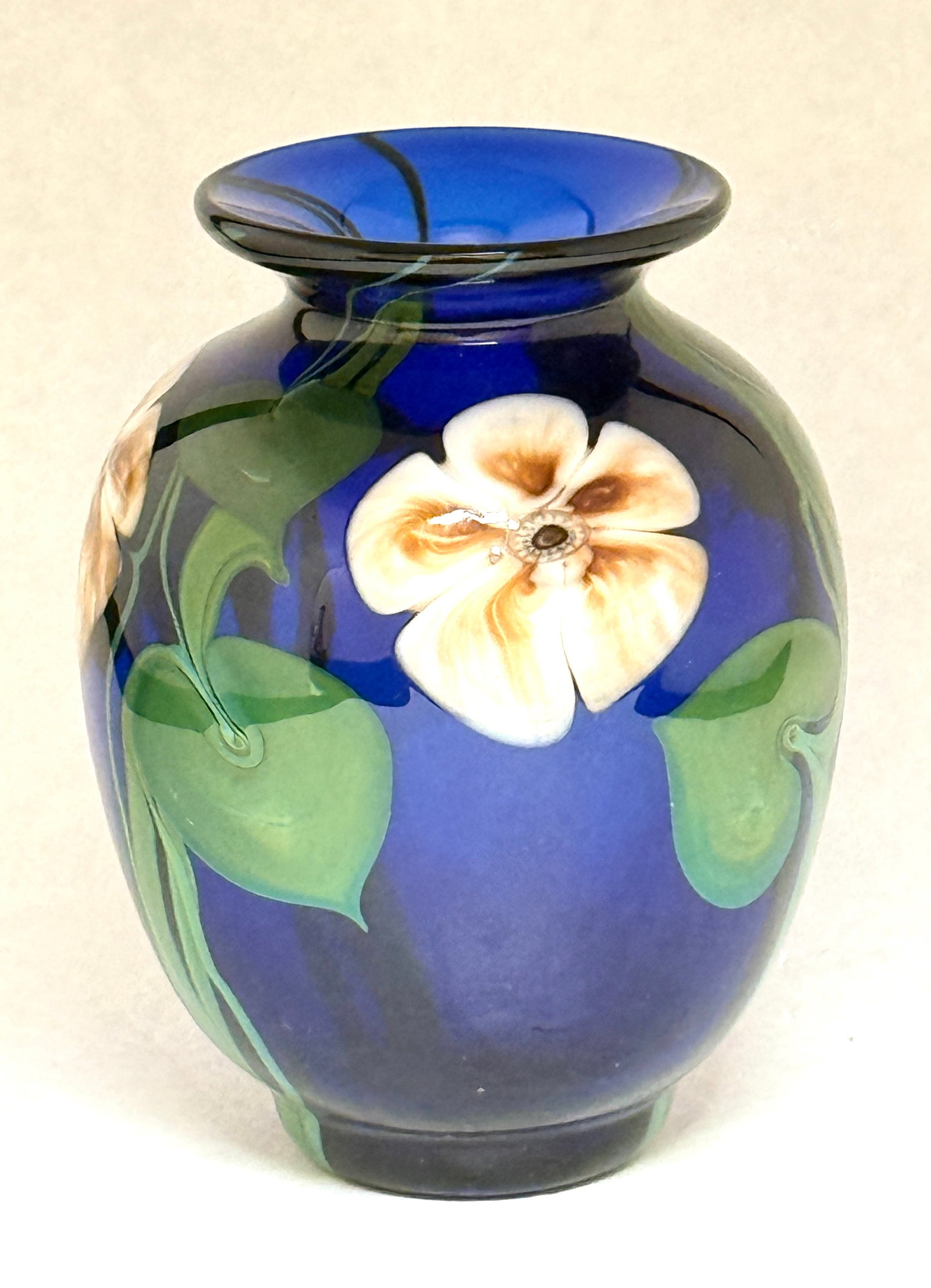 Satava Blue Glass Vase: Satava dark blue translucent glass vase decorated with 3 Multi Flora on green stems, signed R Gibbons Satava 566-83, 5 1/2" ht. CONDITION: no chips, cracks, repairs, or material defects found,