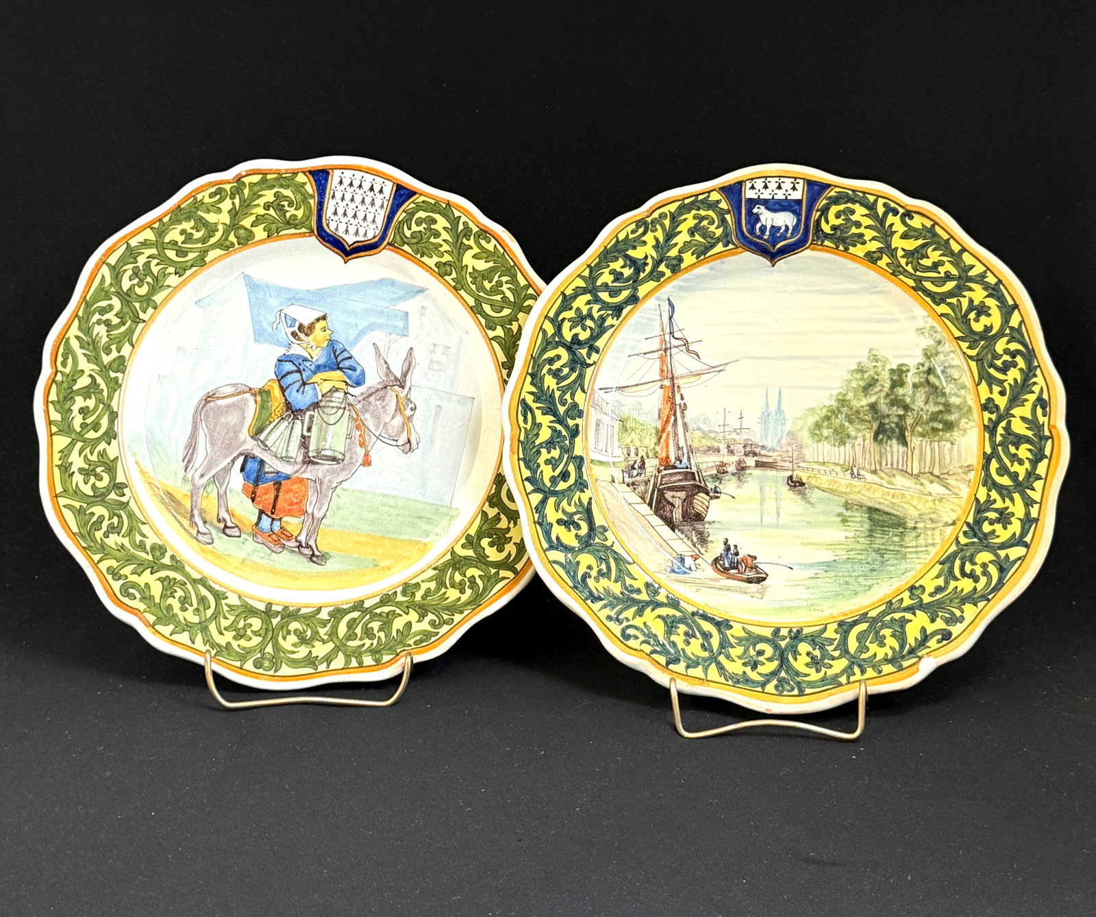2 Porquier Beau Plates: 2 Porquier Beau plates, one Scene of Odefriver and Cathedral, Blason of Quimper and the other Laitiere Bretonne, woman with donkey, Blason of Brittany; diameter 9 1/4". circa 1875-1905. CONDITION: