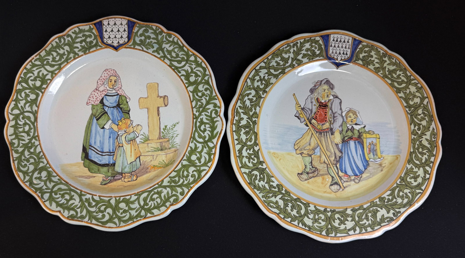 2 Porquier Beau Plates: 2 Porquier Beau plates, "Elliant" Blason of Brittany, grandfather and granddaughter, the other "Quimperle" Blason of Brittany, Bretonne and daughter at cross; diameter 9 1/4". LITERATURE: Tome II