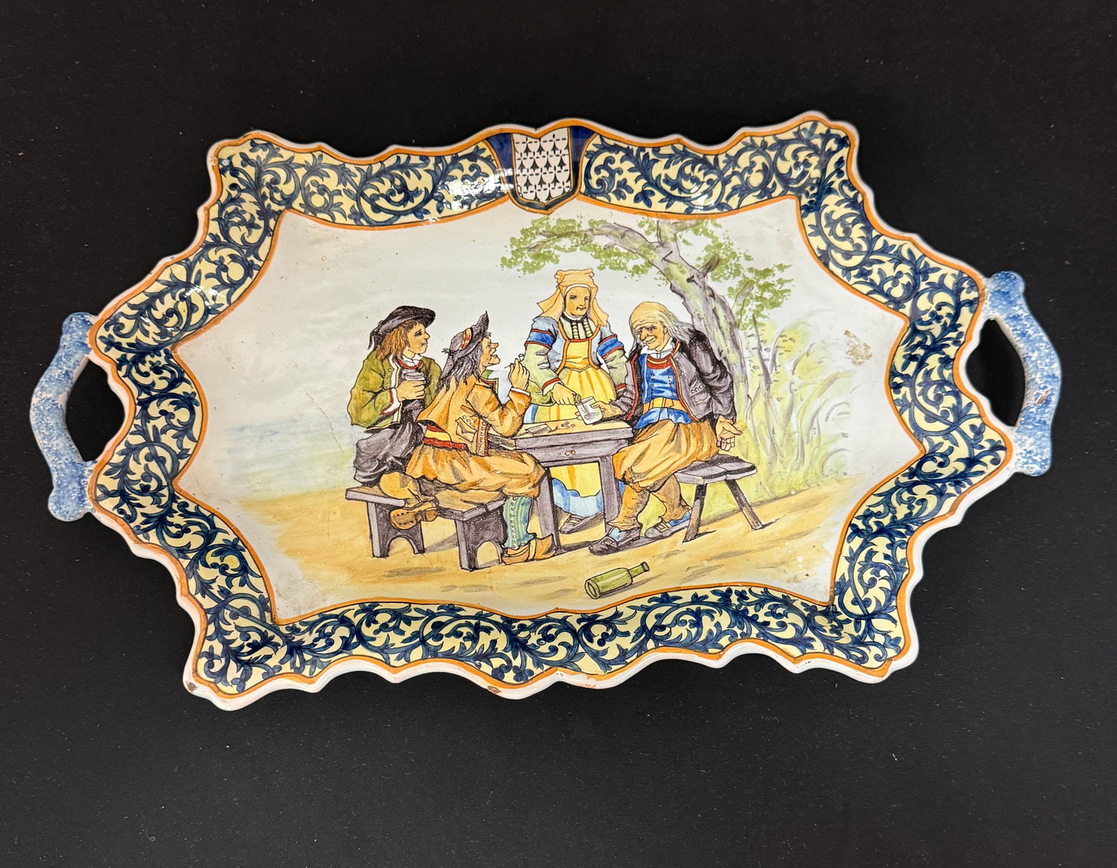 Porquier Beau 2 Handled Bannette: Porquier Beau 2 handled bannette with d?cor riche border and men enjoying a drink. LITERATURE: Tome II page 452 Planche No. 110 "Buveurs de Quimere'h; length 17 1/4" circa 1875-1905. CONDITION: