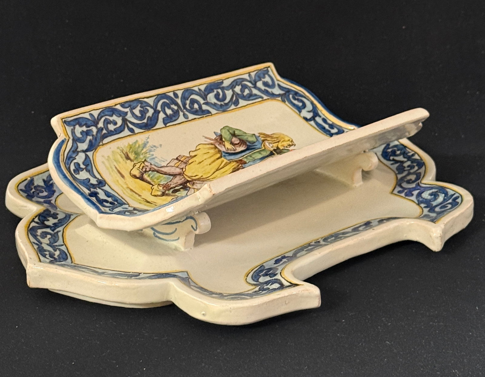 HR Asparagus Server & Underplate: HR asparagus server with underplate, Breton couple dancing and d?cor riche border; length 12 1/2". CONDITION: Quimper has propensity to have minor chips, glaze loss/wear and crazing. Jaremos attempts