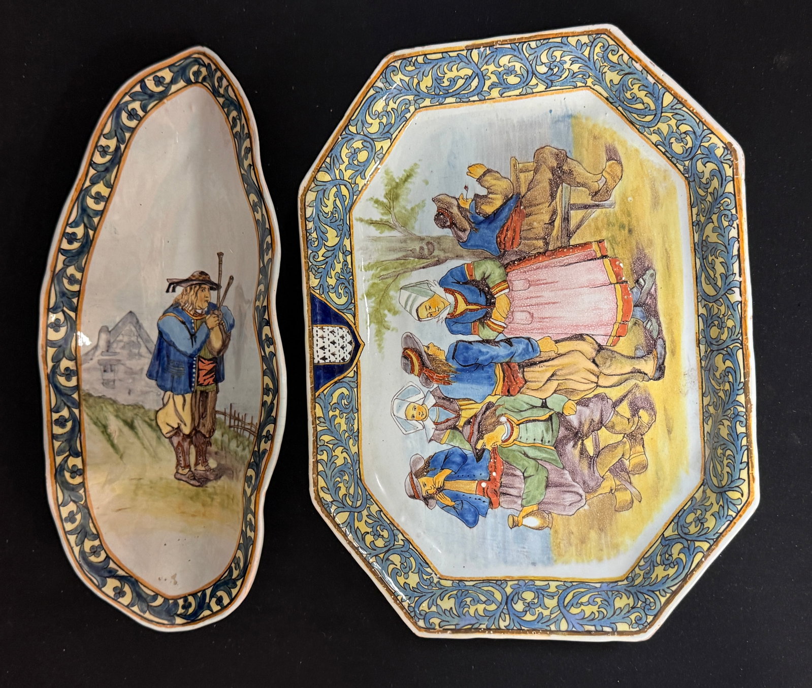 2 Porquier Beau Items: 2 Porquier Beau items including a leaf form ravier with Breton playing a biniou; LITERATURE: Tome II page 421 Planch No 19 "Menetrier d' Audierne" with an octagon platter with blason of Brittany and s