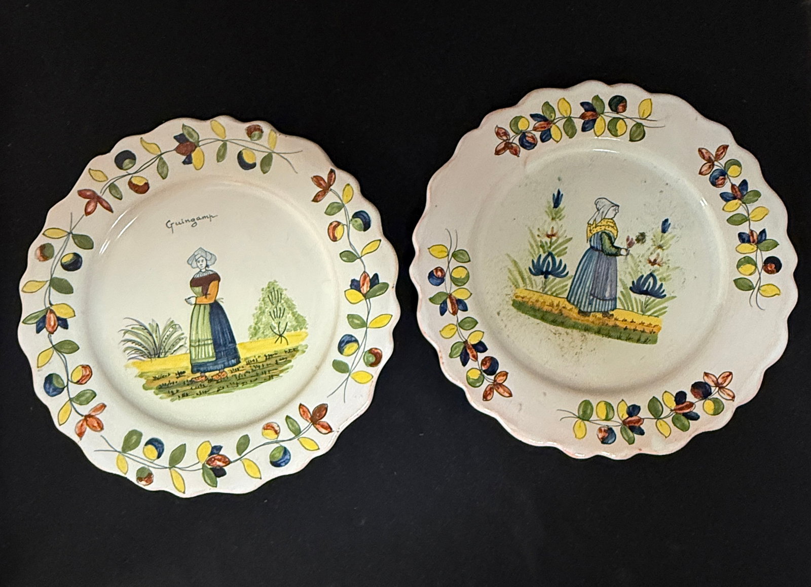 2 LeRoy Dubois Malicorne Plates: 2 LeRoy Dubois Malicorne plates including a Bretonne in the countryside, Made for sale in Guingamp in the Cotes d'Amor area of Brittany, together with a Bretonne holding a small bouquet flanked with