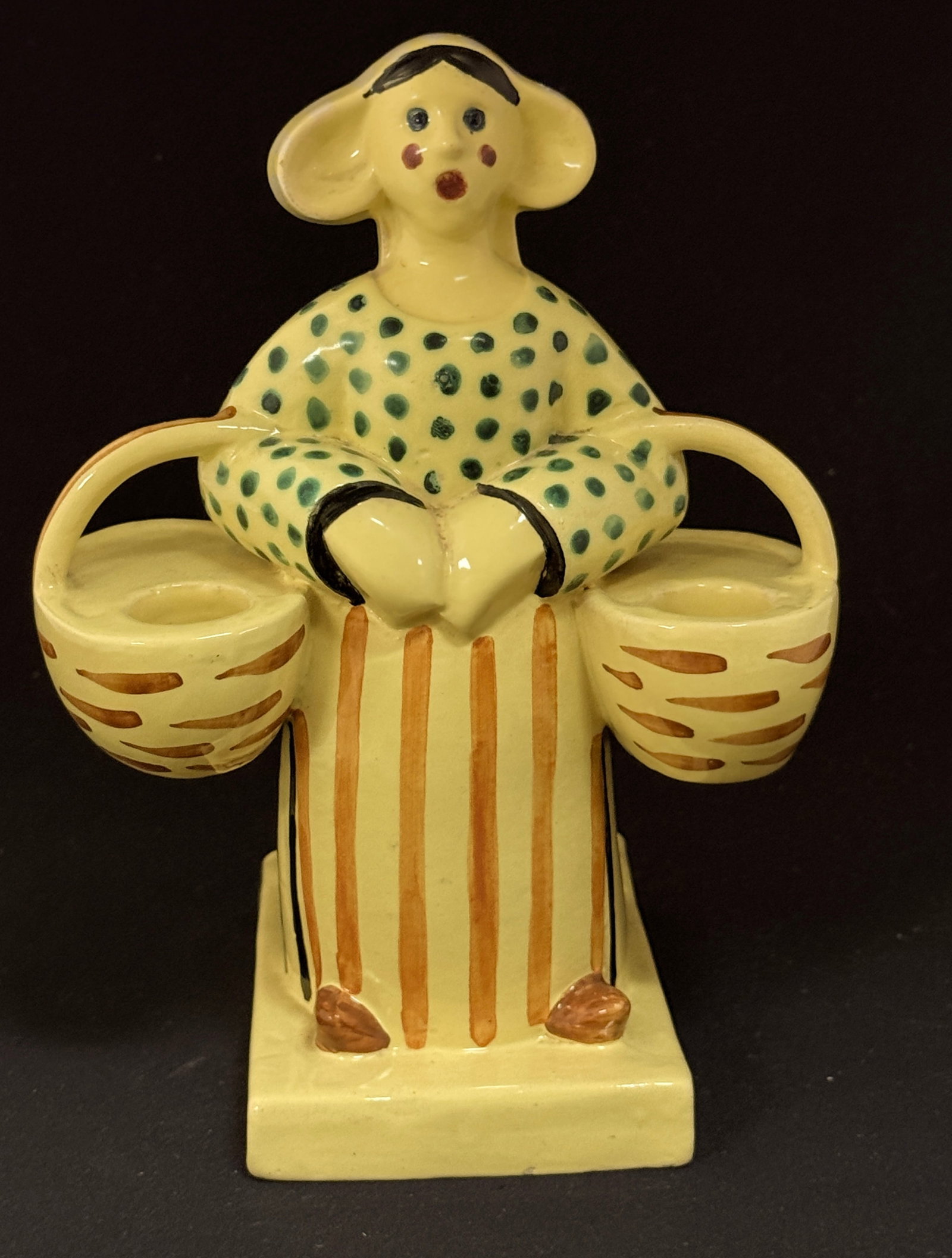 Quimper Polka Dot Bretonne: Unsigned Quimper polka dot Bretonne with baskets yellow, green, and orange; ht. 9" circa 1920-1950. CONDITION: Quimper has propensity to have minor chips, glaze loss/wear and crazing. Jaremos