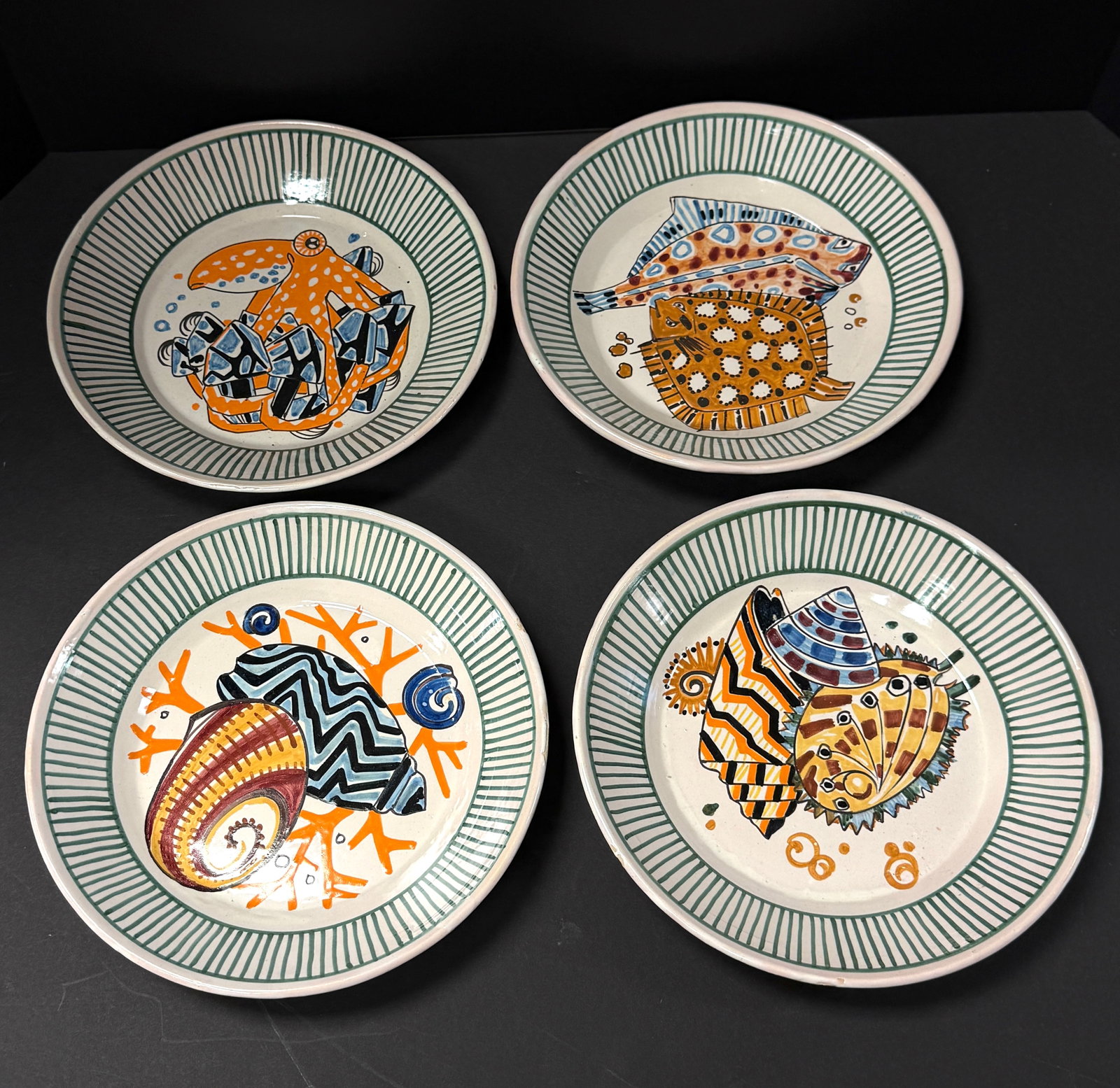 4 Mathurin Meheut Deep Plates: Set of 4 Mathurin Meheut HenRiot Quimper La Mer deep plates depicting an octopus, flounder, and shells; diameter 9 1/4" circa 1920. CONDITION: Quimper has propensity to have minor chips, glaze
