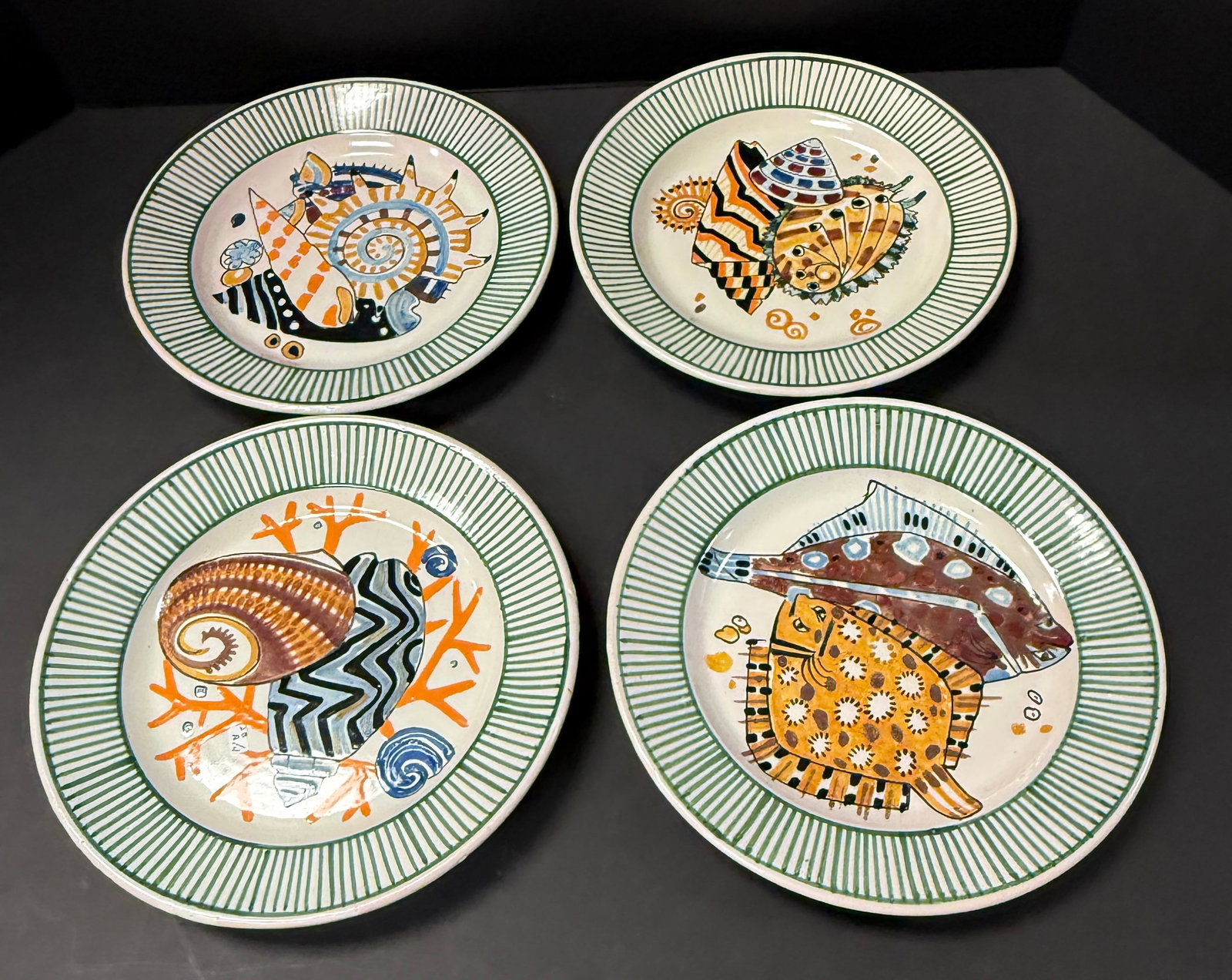 4 Mathurin Meheut La Mer Plates: Set of 4 Mathurin Meheut HenRiot Quimper La Mer plates depicting flounder and shells; diameter 9 1/2" circa 1920. CONDITION: Quimper has propensity to have minor chips, glaze loss/wear and crazing.
