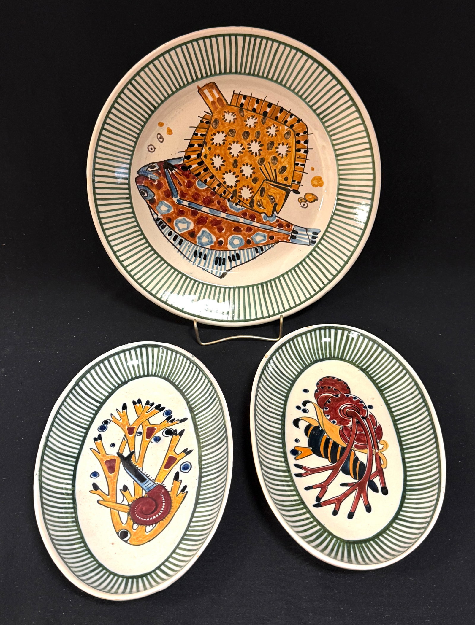 3 Mathurin Meheut La Mer Plates: Set of 3 Mathurin Meheut HenRiot Quimper La Mer plates including a 9" flounder plate and 2 oval 8 1/2" relish dishes with shells. Circa 1920. CONDITION: Quimper has propensity to have minor chips, gla