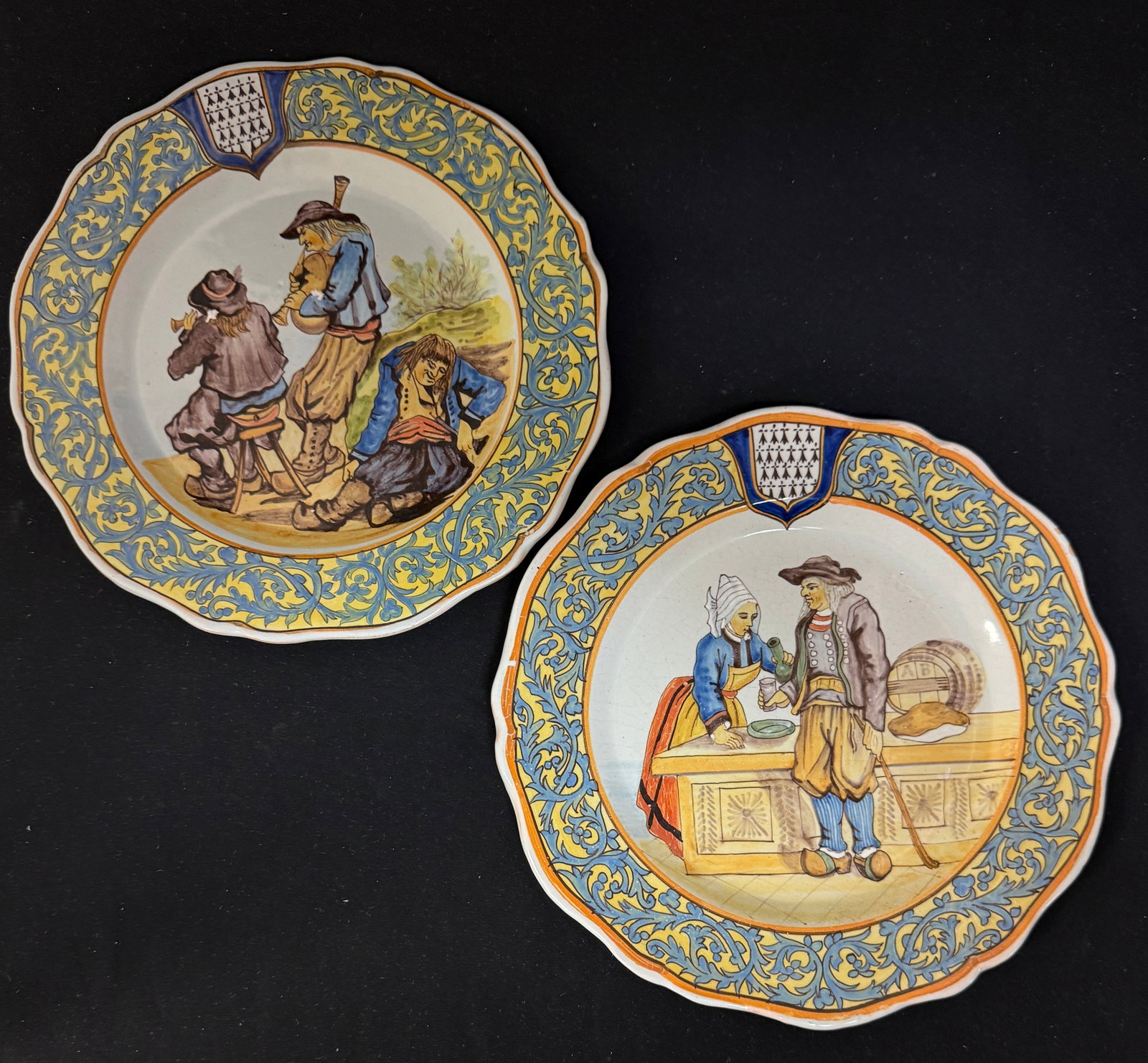2 Porquier Beau Plates: 2 Porquier Beau plates with decor riche borders 1)Playben Breton being served Cider LITERATURE: Tome II page 424 Planche No 25. 2) Breton musicians and one who partied too much; diameter 9 1/2" circa
