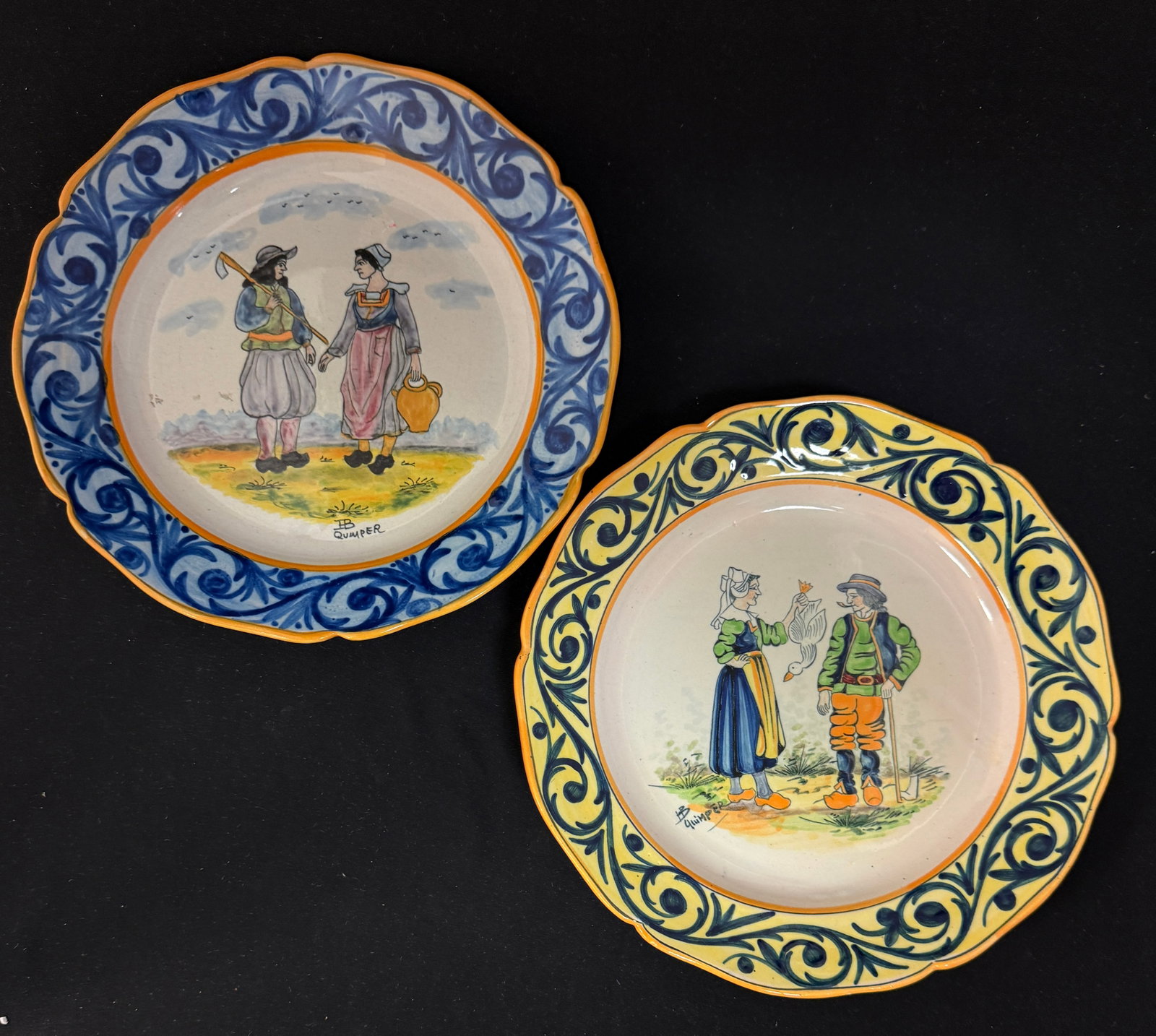 2 HB Quimper Plates: 2 HB Quimper plates 1) Breton couple with duck 2) Breton couple with a cruche and tool; diameter 9 1/2" circa 1930-1950. CONDITION: Quimper has propensity to have minor chips, glaze loss/wear and craz