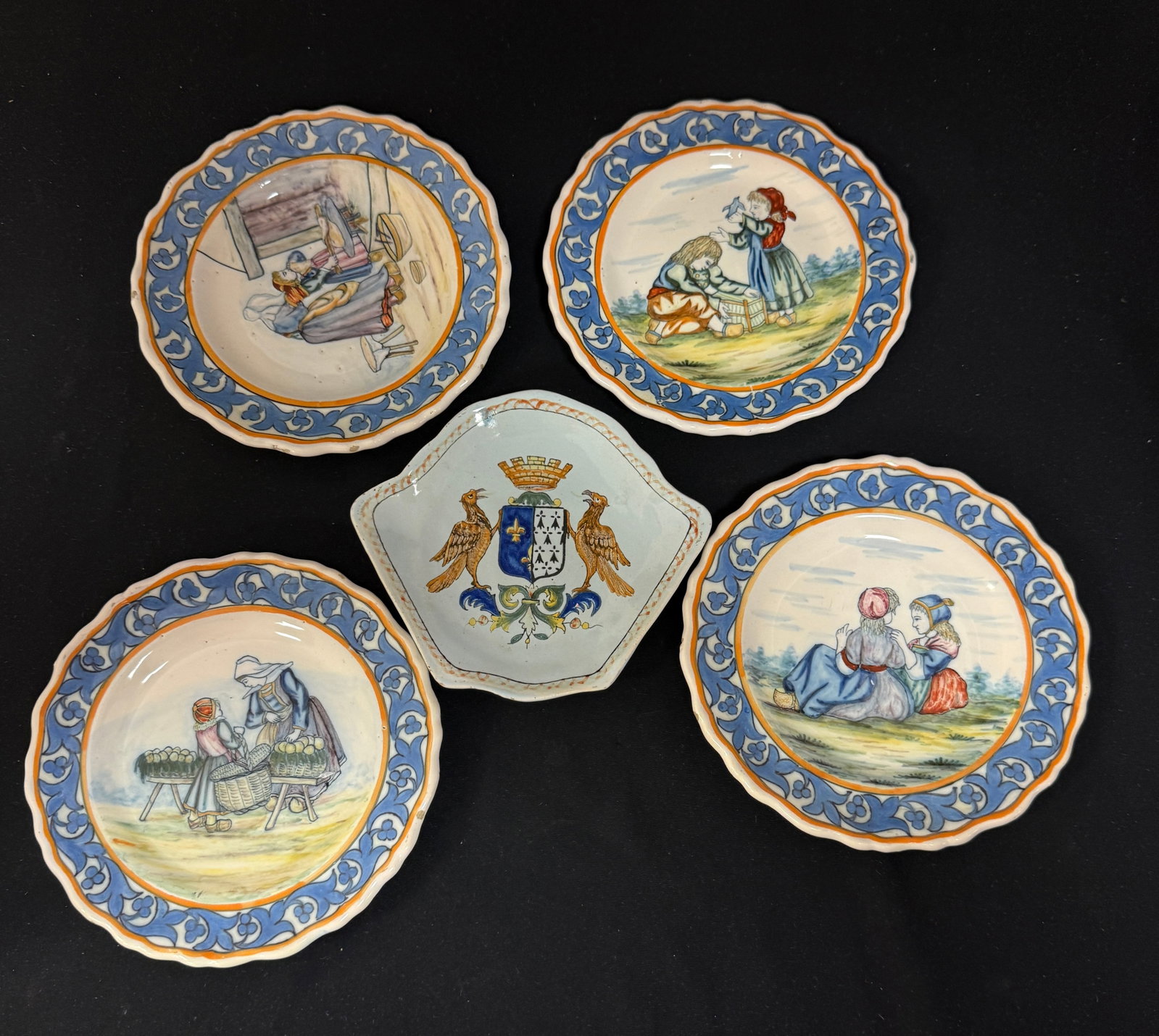 5 Porquier Beau Items: 5 Porquier Beau and Porquier Quimper items including a rare set of 4 children's plates with charming scenes and a Porquier Beau shield shaped plate with blason of Brest; largest 6 1/4" diameter circa 
