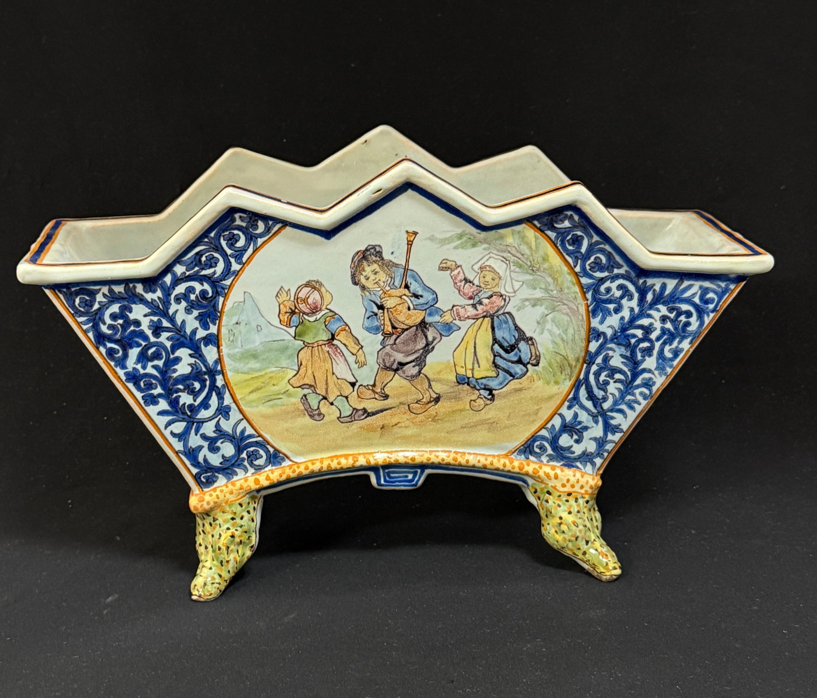 Porquier Beau Jardiniere: Porquier Beau jardiniere with crocodile feet, d?cor riche border. LITERATURE: one side Tome II page 449 Planche No 106 Bannalec children dancing; other side TomeII page 451 Planch No 107 First Steps;