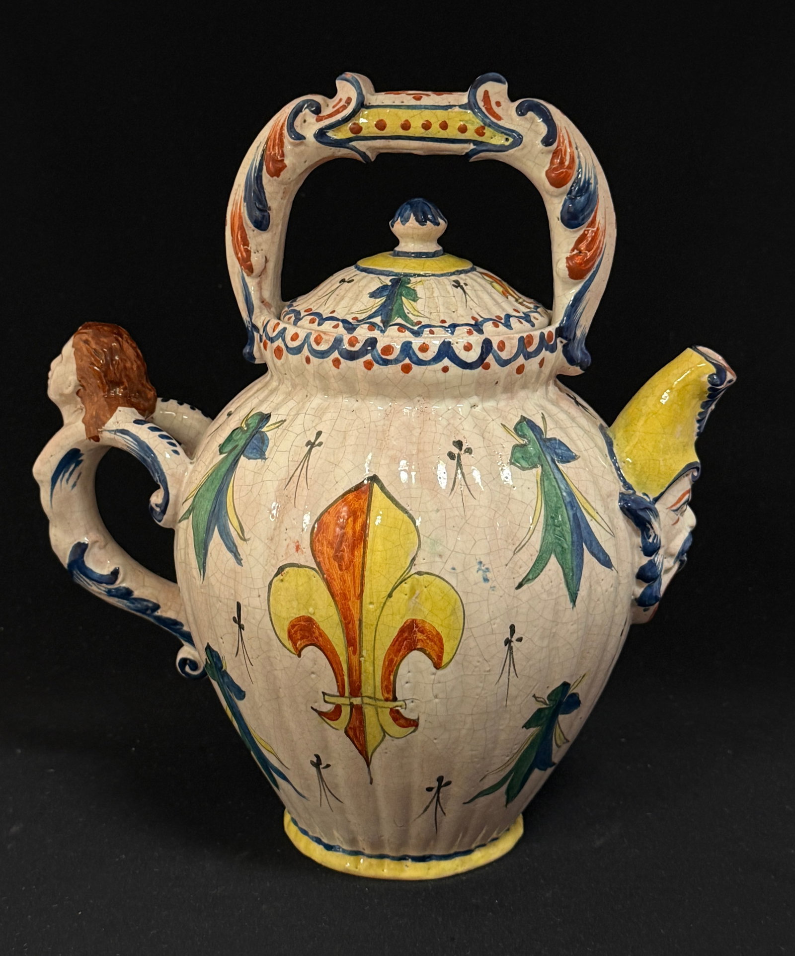 Alcide Chaumeil Teapot: Alcide Chaumeil teapot #54 with figural spout and handle, blason and Fleur de Lis and ermine motifs; ht. 10 1/5" circa 1880-1919. CONDITION: Quimper has propensity to have minor chips, glaze