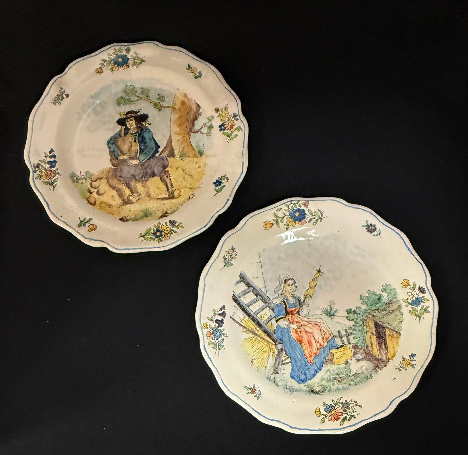 Exceptional Pair HB Plates: Exceptional pair HB plates1) young Bretonne with spinning wheel and a white rabbit in farmyard setting 2) Breton seated under a tree playing a biniou with village scene in background, delicate colors