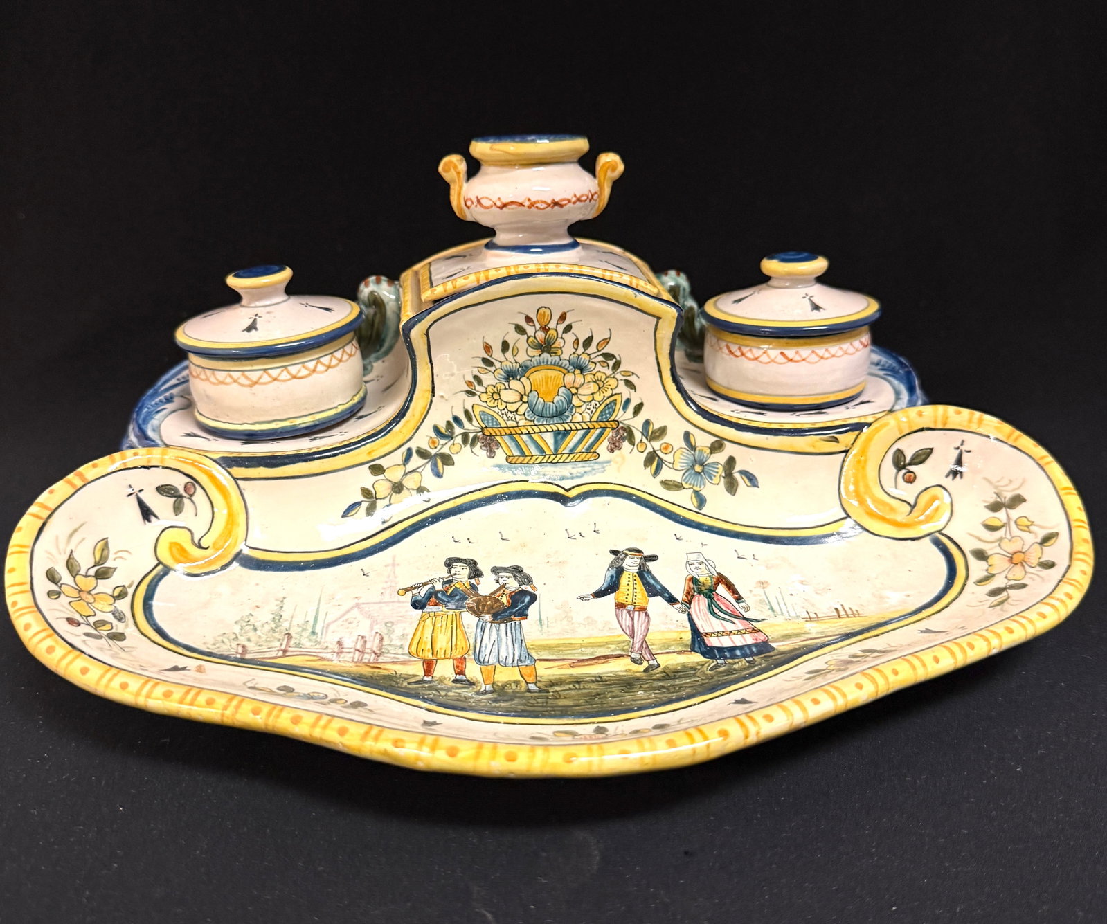 HB Quimper Double Inkwell: HB Quimper double inkwell and pen tray with finely painted floral motif, a basket with floral arrangement and a central scene of Breton couple accompanied by two musicians playing a bombarde and
