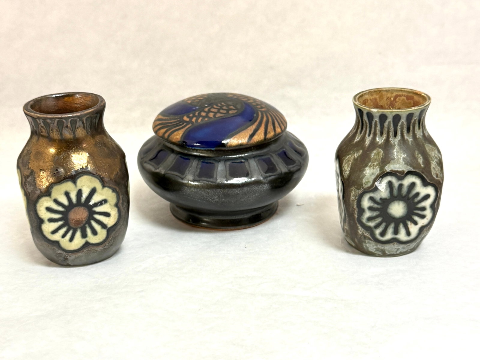 3 HB Quimper Odetta Items: 3 HB Quimper Odetta items 1) a stoneware lidded jar with fish in triskele pattern 2) 2 small vases; ht 3 1/4" circa 1920-1930. CONDITION: Quimper has propensity to have minor chips, glaze loss/wear