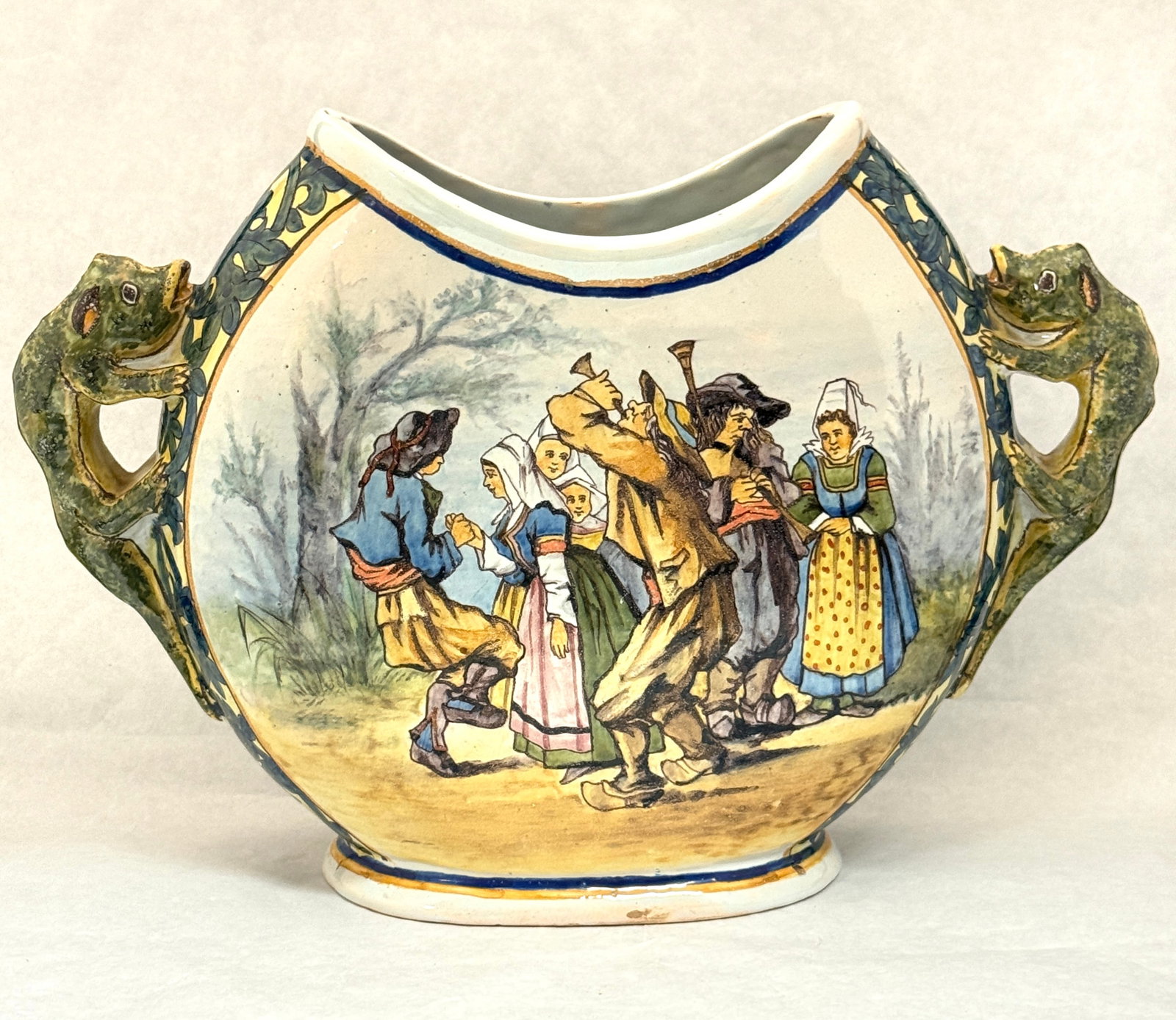 Porquier Beau Moon Vase: Porquier Beau moon vase with lizard handles and a botanical motif back and Breton celebration scene on front; ht. 10", circa 1875-1905. LITERATURE: Tome II page 452 Planche No 109 "Bannalec".