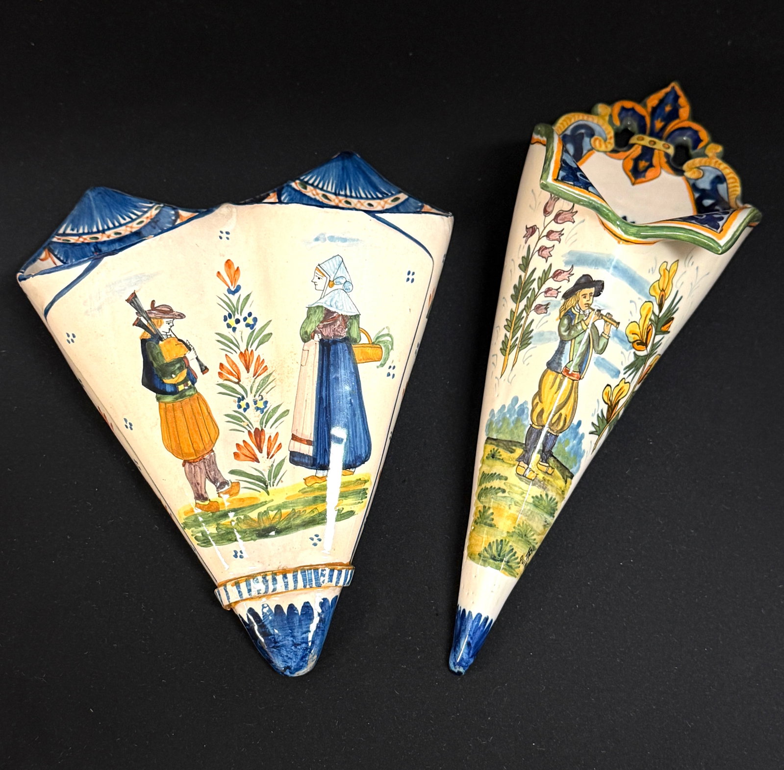 2 Quimper Cornet Wall Pockets: 2 Quimper cornet form wall pockets 1) HR Quimper with Fleur de Lis motif at top, ermine tails, d?cor riche border and Breton playing a bombarde flanked by sprays of ajonc and bruyere 2) HenRiot