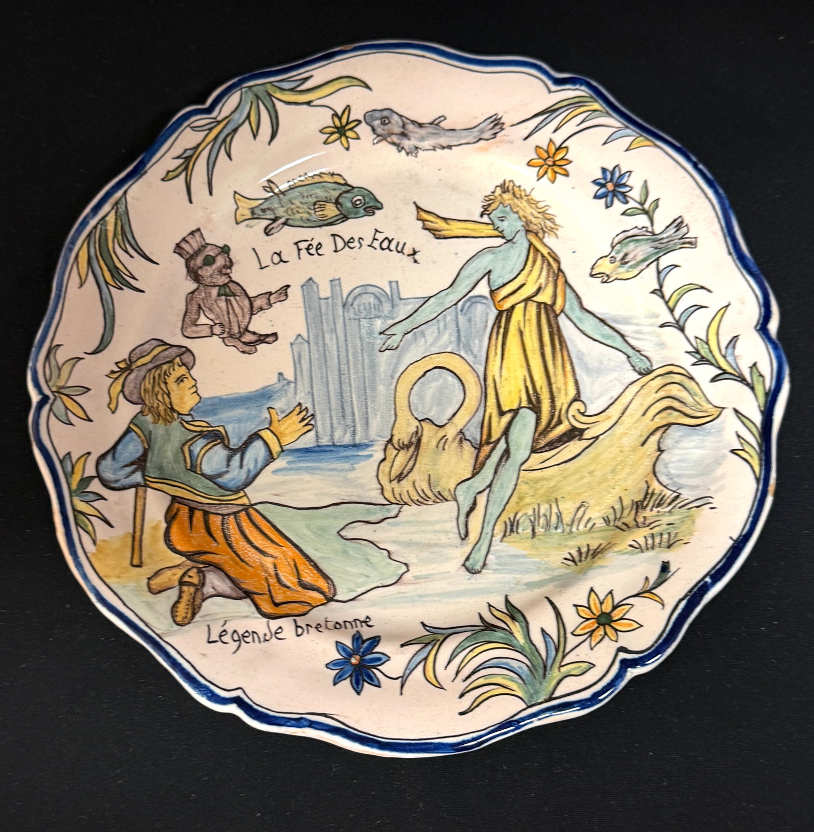 Rare Porquier Beau Quimper Plate: Rare Porquier Beau Quimper "Legende Breton" plate, "La Fee Des Eaux" Breton folklore tale of a young man, Houarn, trapped by the Water Fairy on the Isle of Lok along with her former lovers. Houran's b