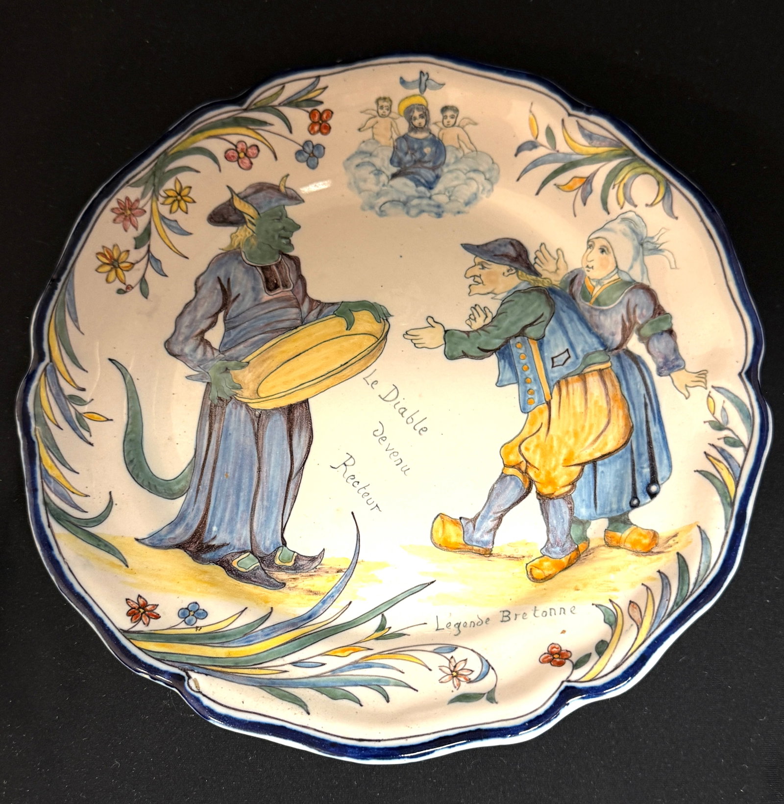 Rare Porquier Beau Quimper Plate: Rare Porquier Beau Quimper "Legende Breton" plate, "Le Diable devenu Recteur", the devil who became a Rector; a demonic figure assumes the identity of a parish priest, he misleads villagers by