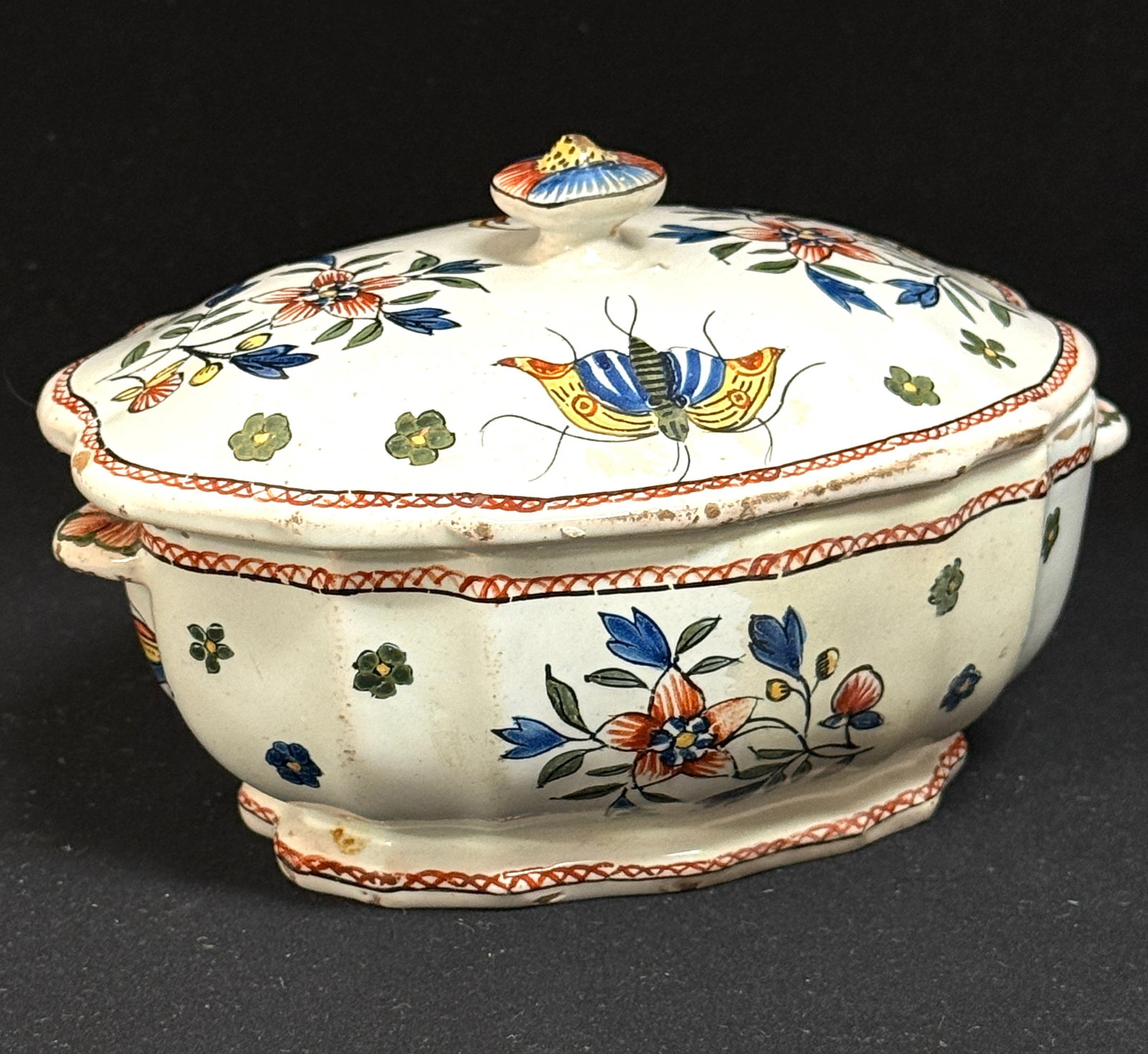 HB Oval Box: HB oval box with Rouen style decor of flowers, birds, butterflies ad handles; length 6 1/2" circa 1860-1870. CONDITION: Quimper has propensity to have minor chips, glaze loss/wear and crazing.