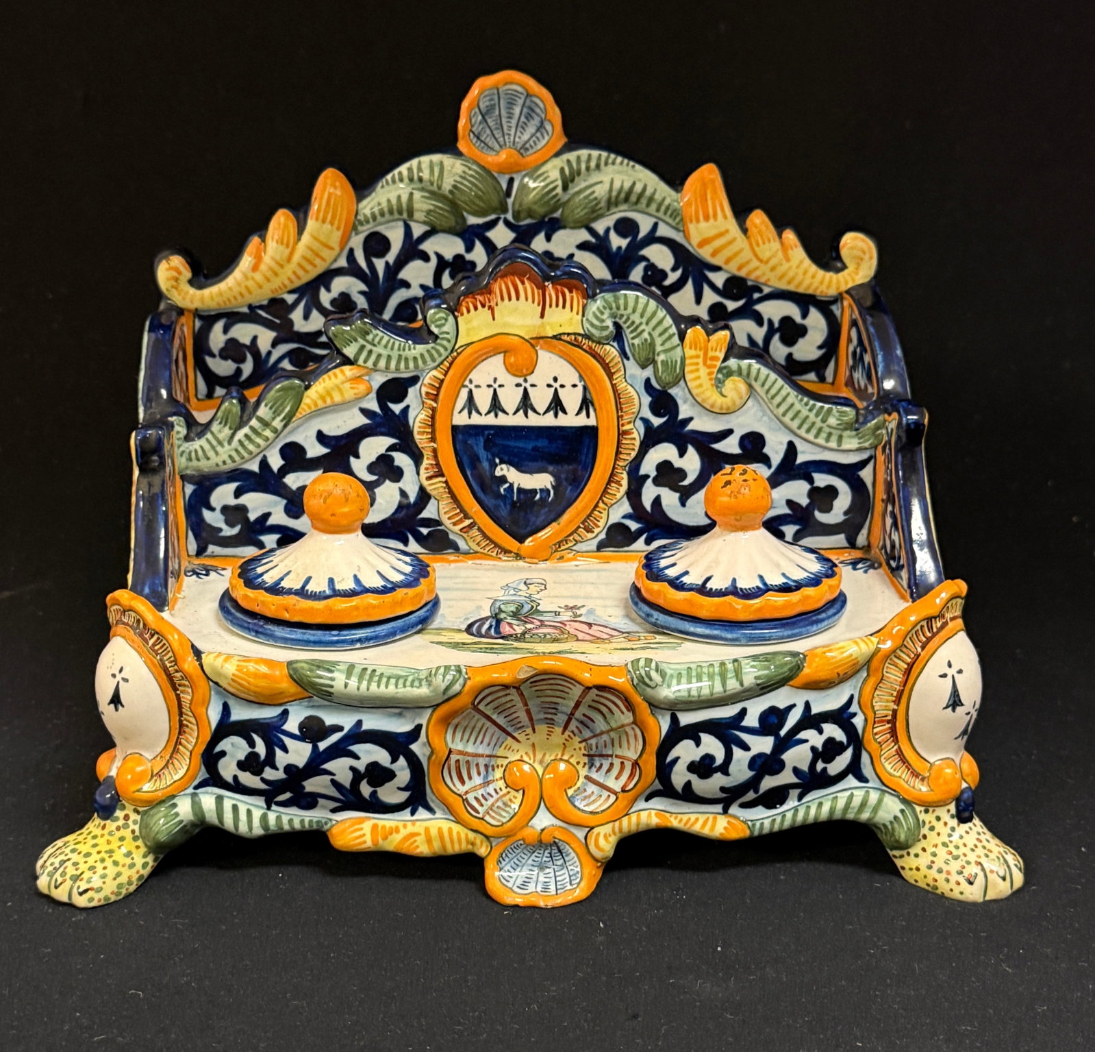 HenRiot Quimper Double Inkwell: HenRiot Quimper double inkwell with letter holder on paw feet with shell motif, d?cor riche, ermine tail, Blason of Quimper; ht. 6 1/2" circa 1920. CONDITION: Quimper has propensity to have minor