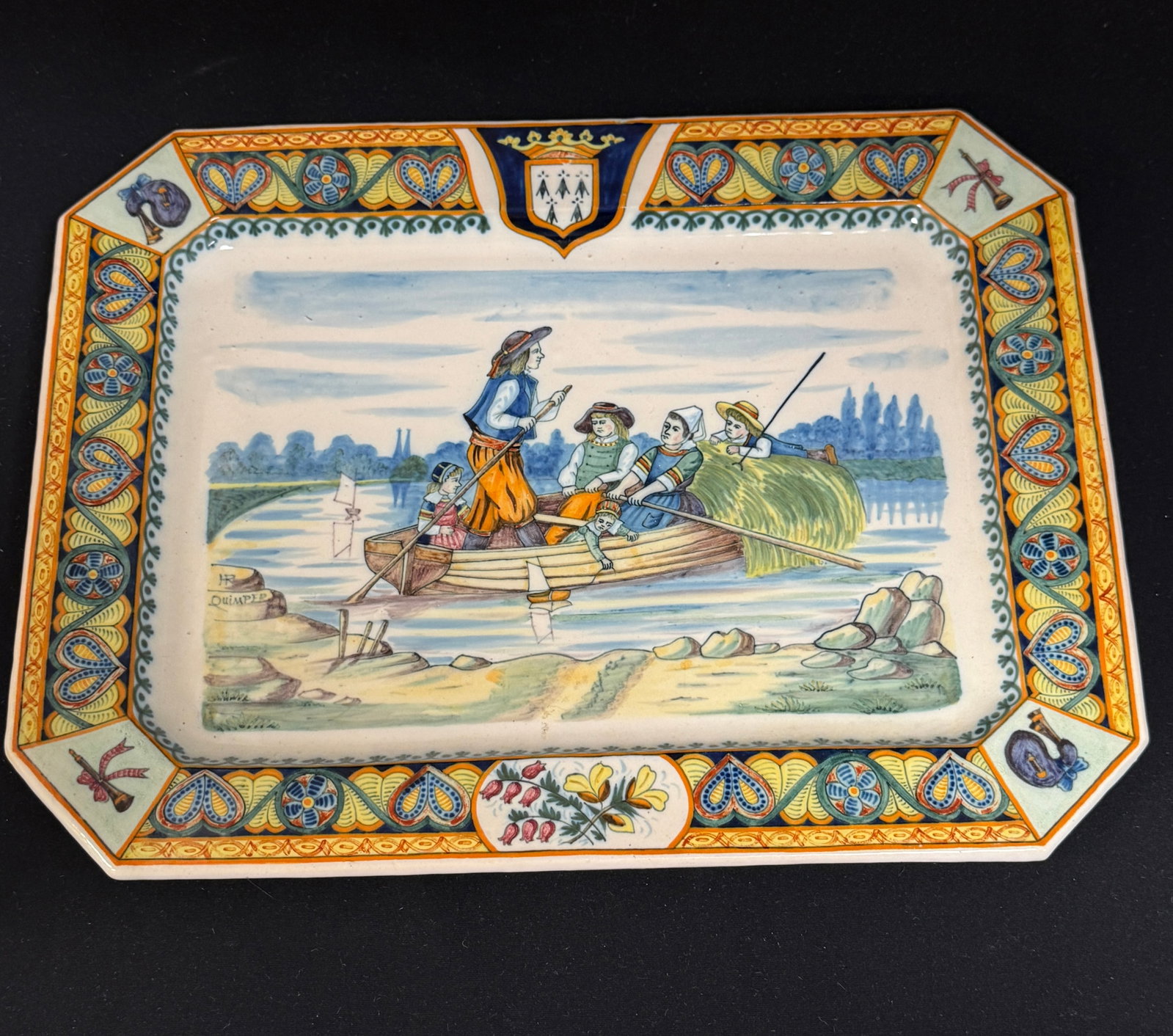 HR Quimper Rectangular Platter: HR Quimper rectangular platter with intricately painted Celtic motif border, bombards and binious in corners and topped with Blason of Brittany, the center has scene of family in boat, twin cathedral
