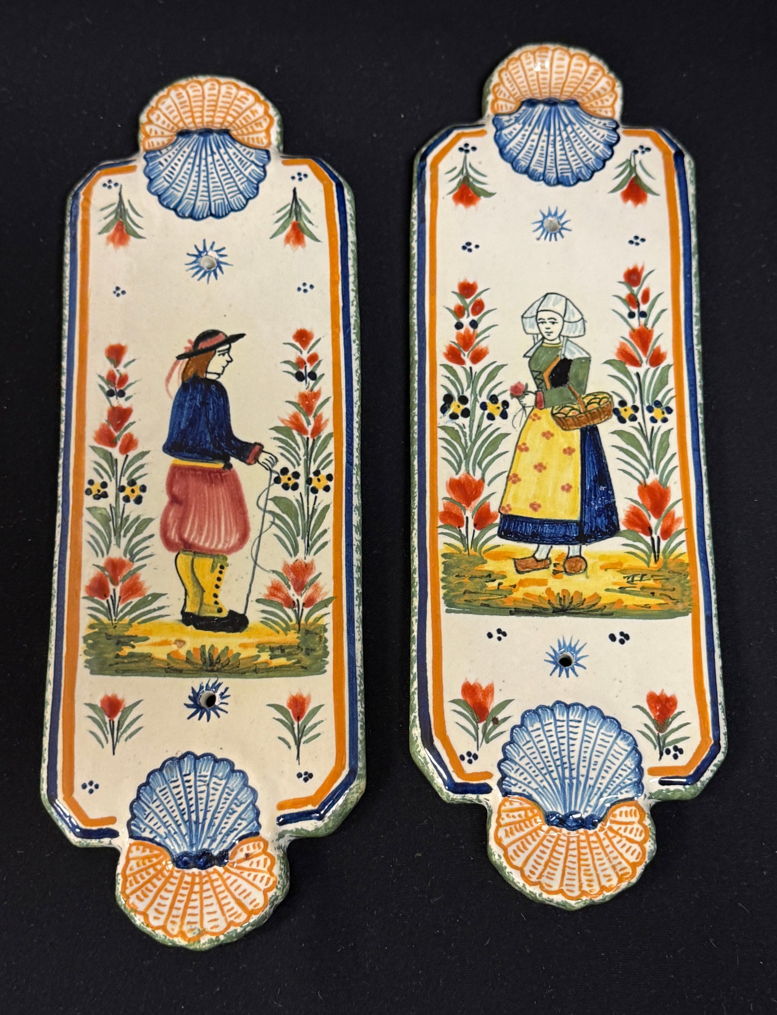 HenRiot Quimper Door Push Plates: Pr. HenRiot Quimper door push plates with Bretons, delicate dimensional shell motif, 4 dot designs, a la touch floral sprays and sponged edges; length 10 1/4" circa 1920-1940. CONDITION: Quimper has