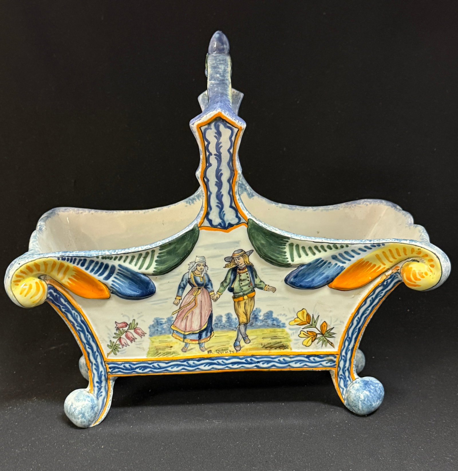 HR Quimper Basket Jardiniere: HR Quimper basket jardiniere with handle and raised by 4 sponged and scrolling feet, one side decorated with Blason of Brittany flanked by rampant lions, the opposite is adorned with sprigs of ajonc a