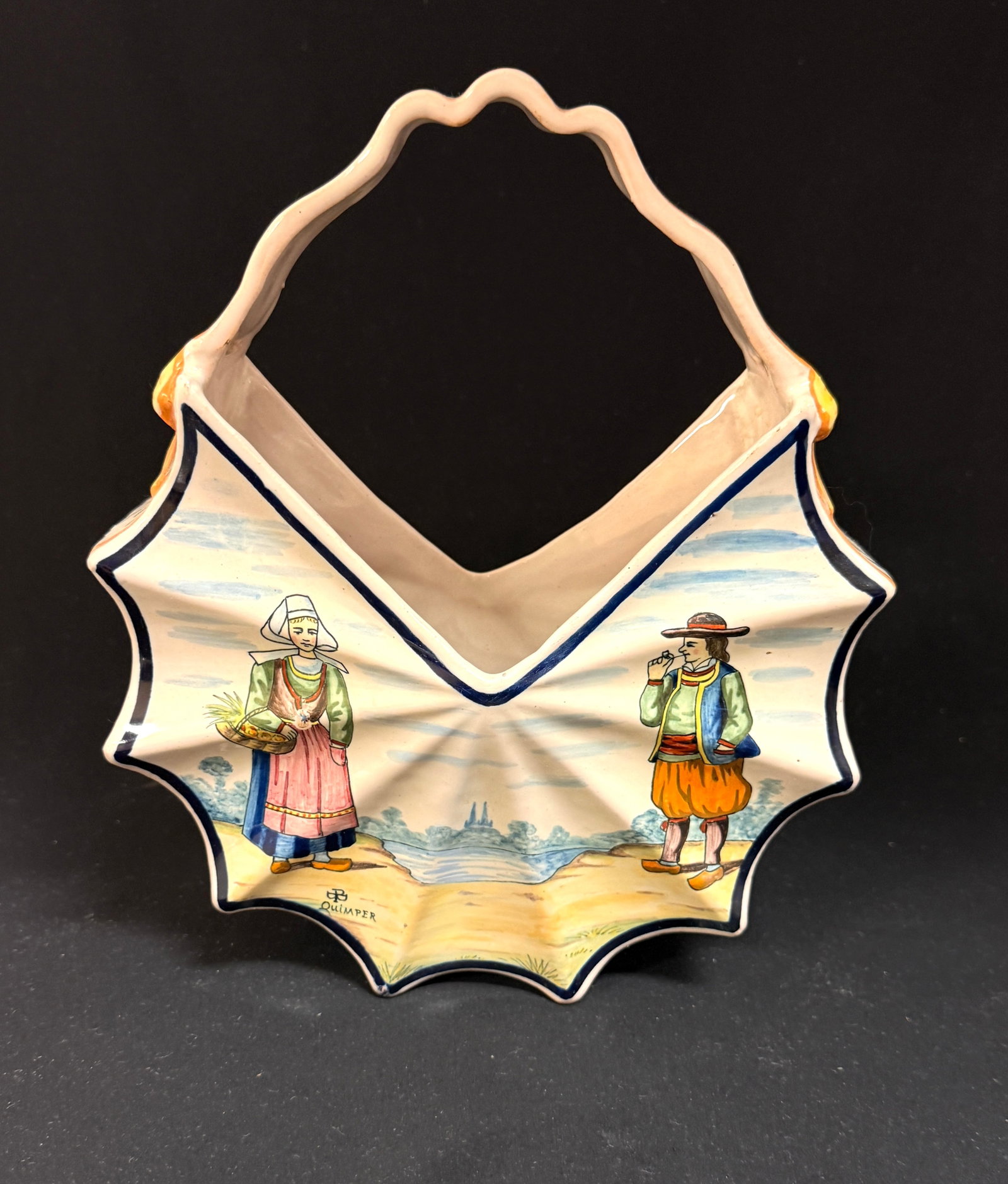 Porquier Beau Quimper Jardiniere: Porquier Beau Quimper pleated basket form jardiniere with ribbon handle affixed by bows and d?cor riche banding, one side with botanical floral sprays and the other a Breton couple with camieu-bleu