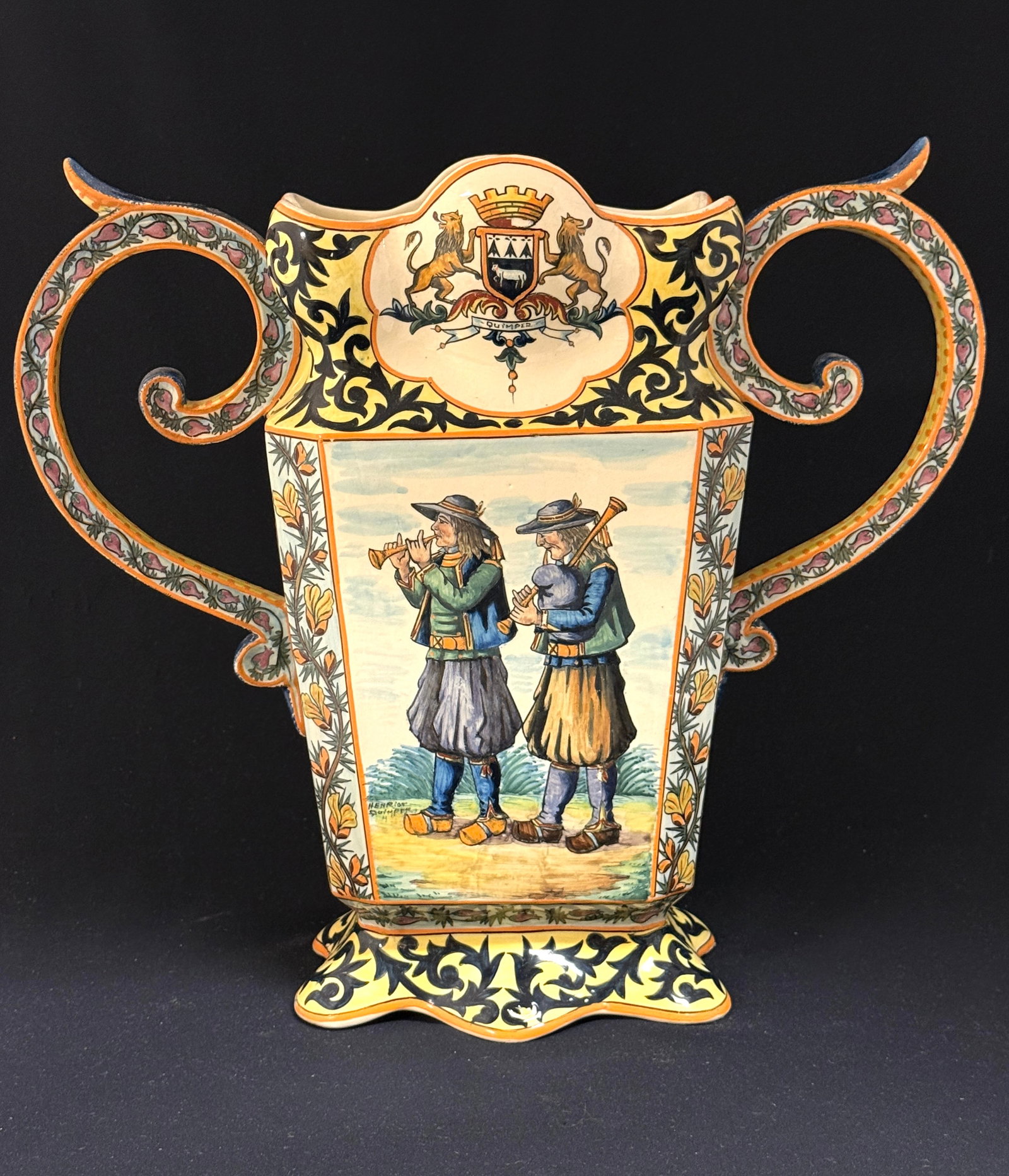 Magnificent HenRiot Quimper Vase: Magnificent HenRiot Quimper vase with large scrolling handles decorated with bruyere, Blasons of Quimper and Brittany, side panels of d?cor riche, topped with band of bruyere, one side panel has scene