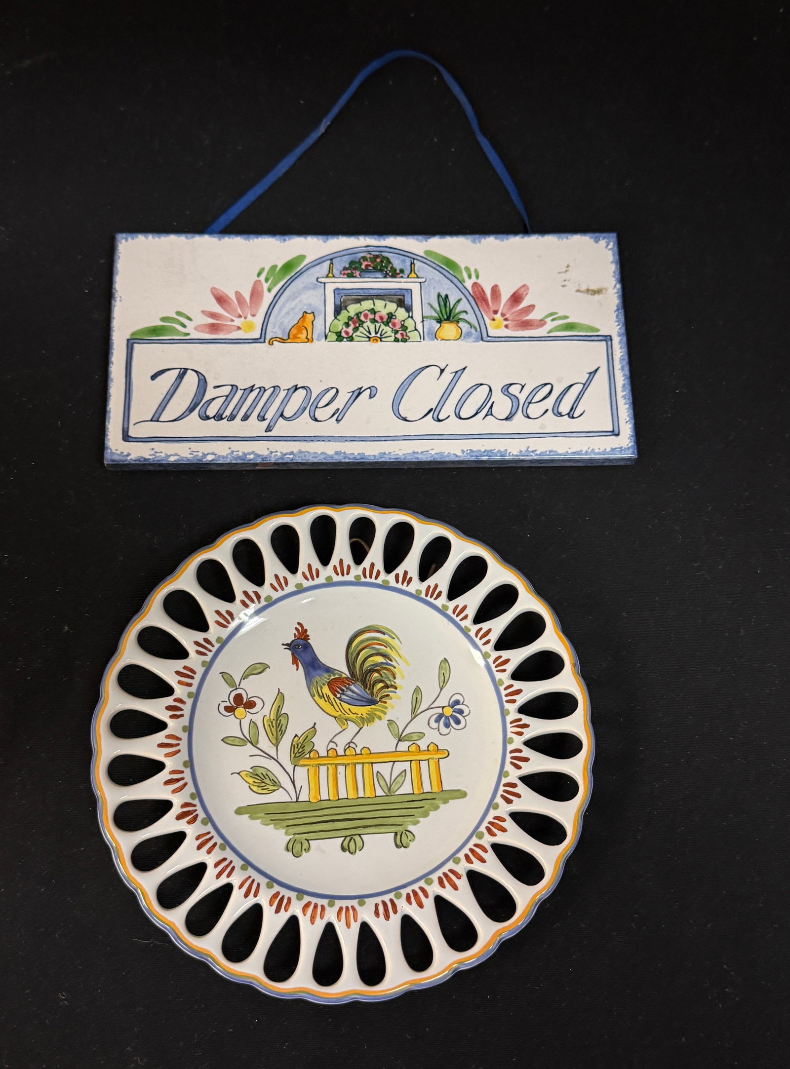 2 French Faience Items: A reticulated plate marked Decor Rouen Fait Main Geo Martel AG VII with French Coq perched on a fence together with a hand decorated tile "Damper Closed"; longest 7 3/4" circa 20th Century.